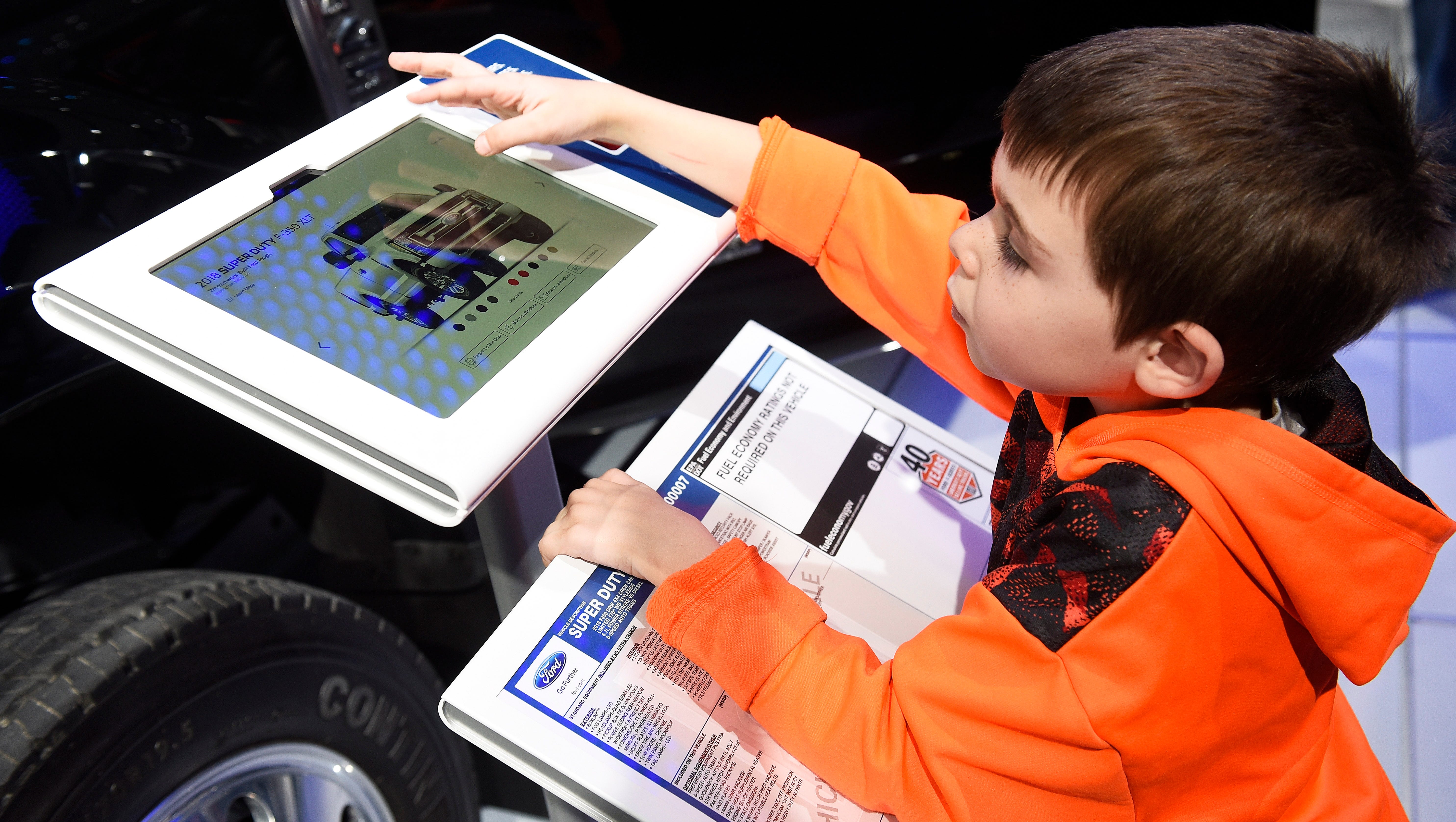 Daniel Pershyn-Tikh, 6, of Bloomfield Hills, interacts with the 2018 Ford F450 Super Duty electronic information wheel stand.