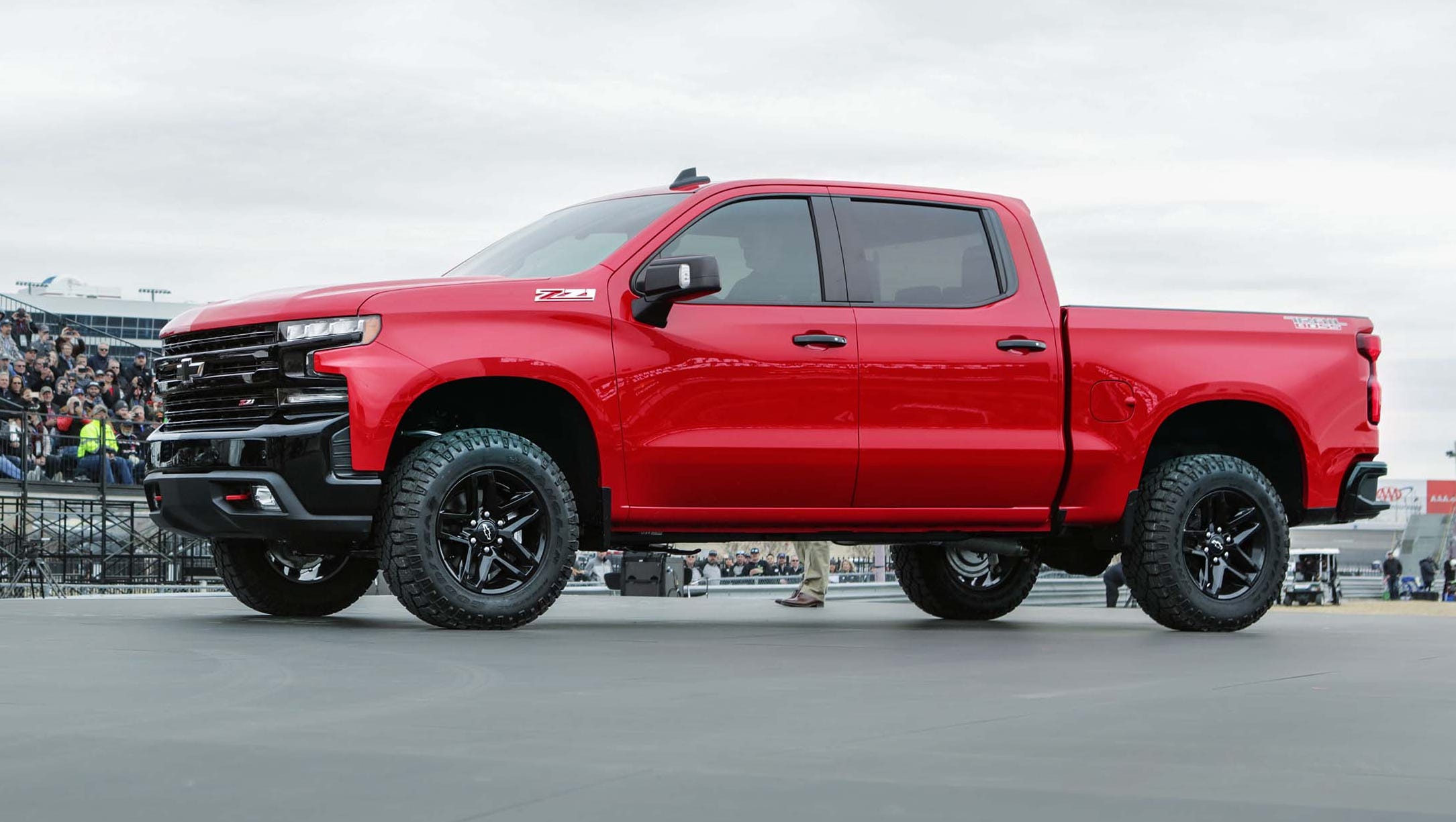 After being lowered into Texas Motor Speedway by chopper, the 2019 Chevy Silverado pickup was paraded before some 1000 Chevy customers who were celebrating 100 years of Chevy trucks.