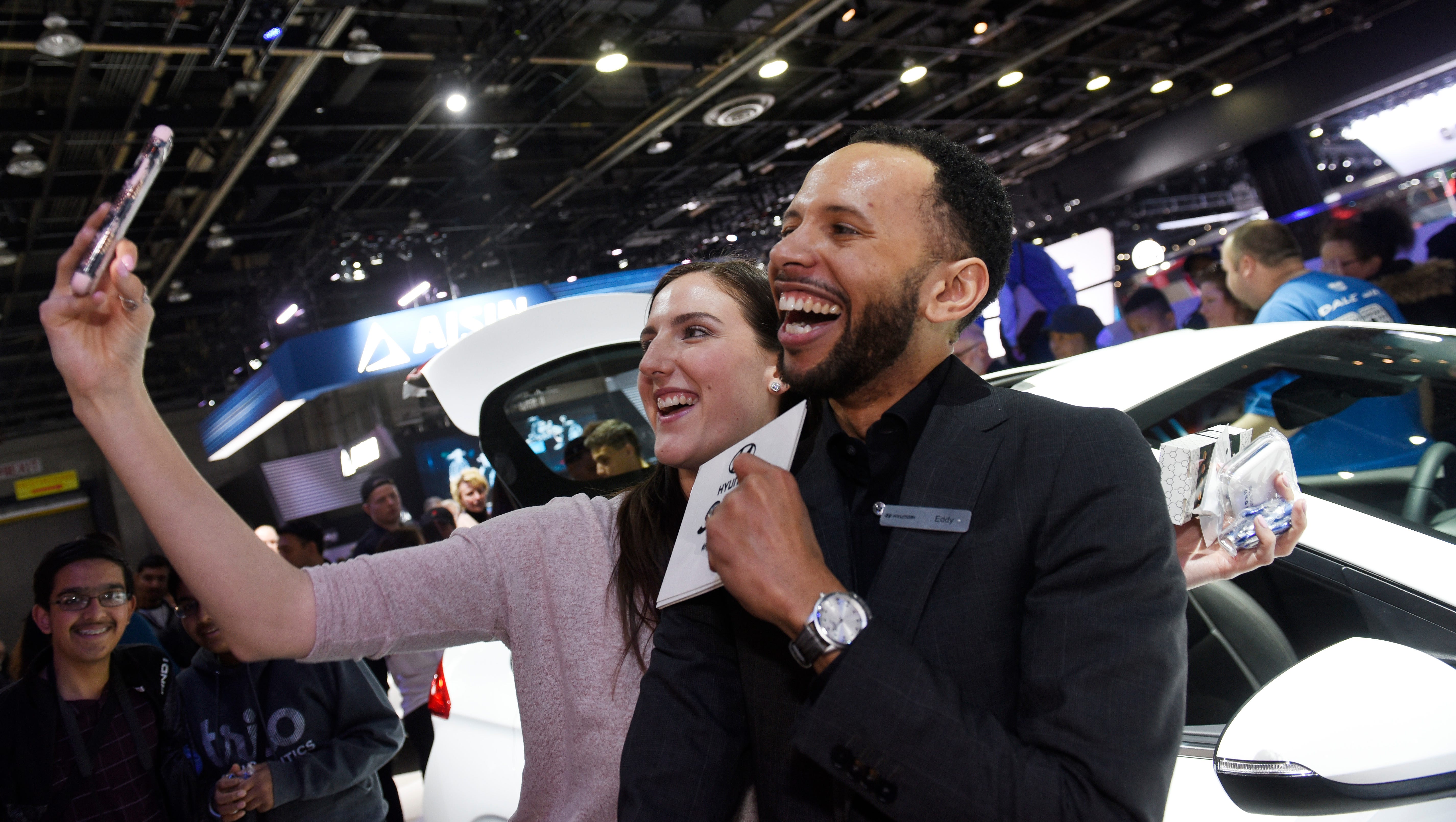 Allison De Orio, 27, of Farmington takes a selfie with Eddy Jones, a product specialist in front of the 2018 Hyundai Ioniq hybrid.