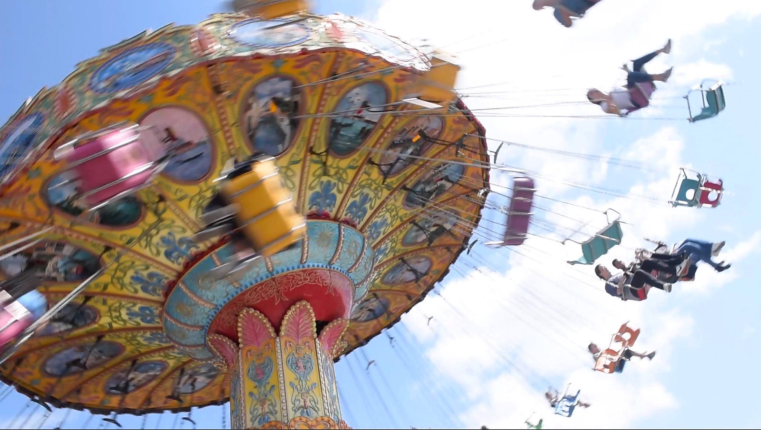 People ride the flying chairs at the Michigan State Fair.