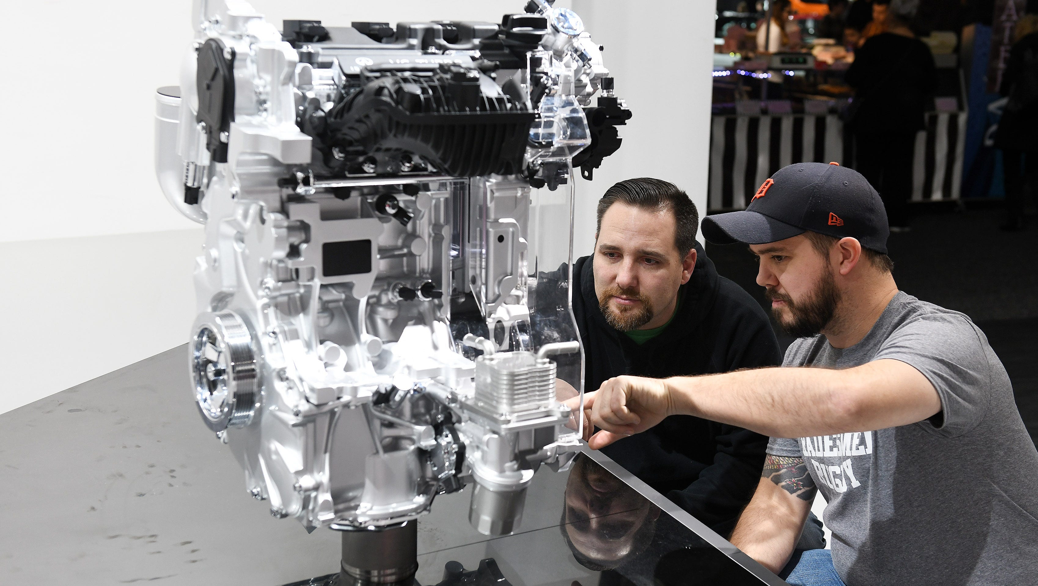 Christopher Rowe, right, 39, of Brownstown and Brent Tobiczyk, 35, of Royal Oak check out the Infiniti variable compression engine model.