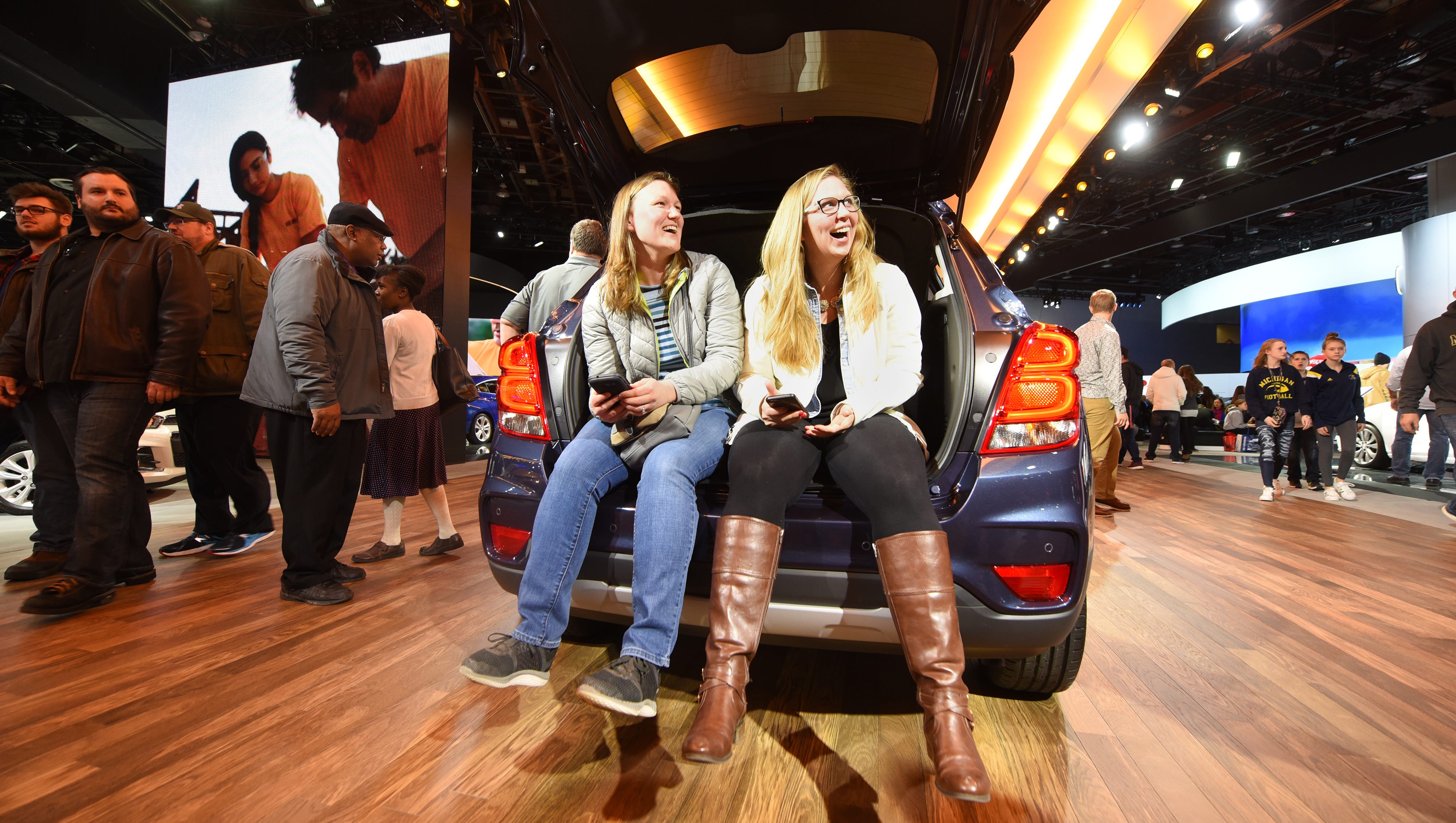 Liz Connolly (left), of Franklin, and Catherine Tippman, of Berkely, share a moment inside the hatchback of a 2018 Chevrolet Trax Premier on Saturday January 20, 2018 for the first public day for the North American International Auto Show