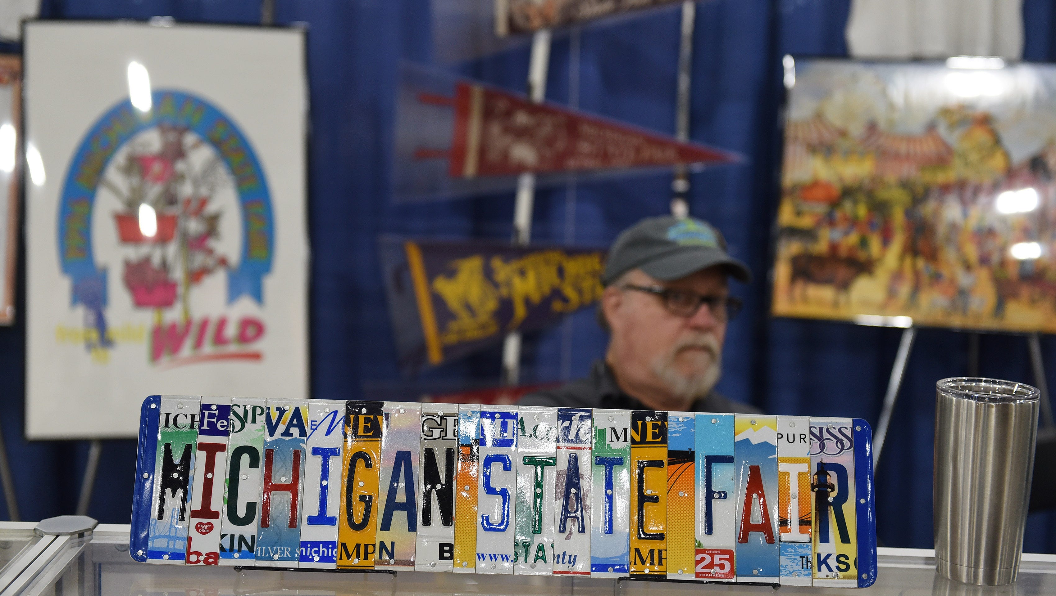 Historian Bob Cummings of Novi sits at his booth of State Fair memorabilia.