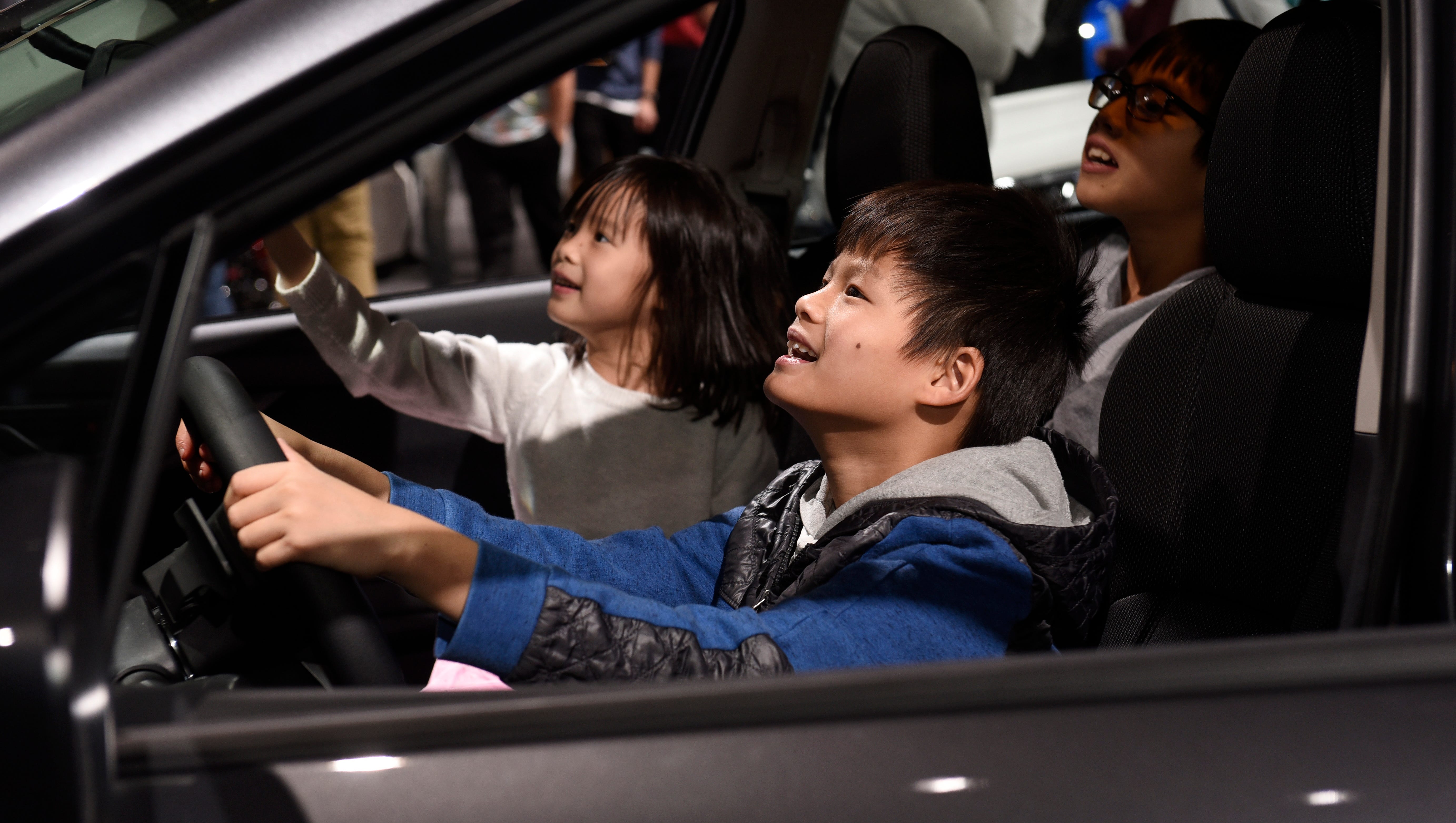 Ronny Le, 9, and his sister Luci Le, 5, of Southfield, check out the interior of the 2018 Subaru Impreza.