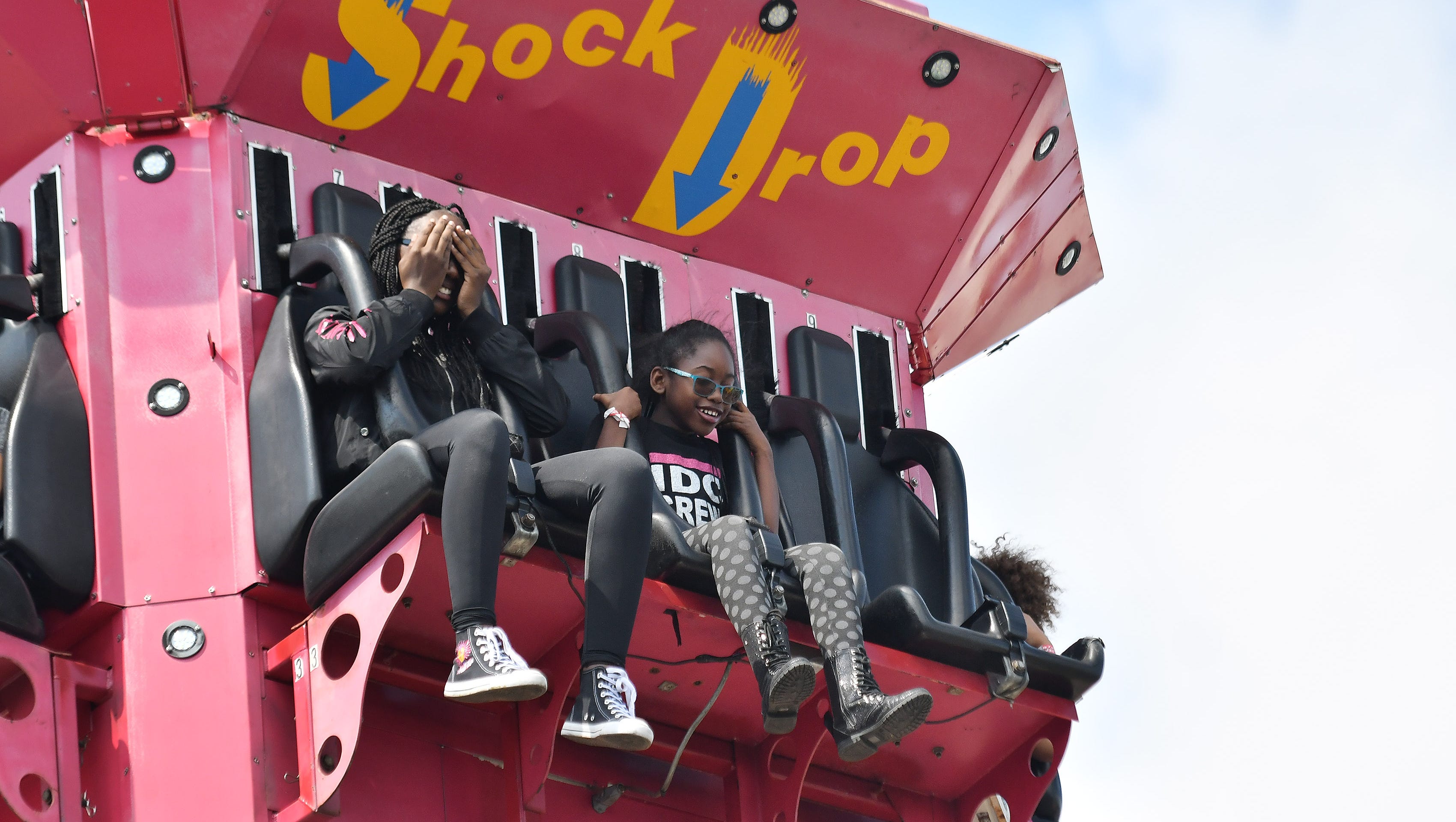 LaJayda Foster, right,13, covers her eyes as she and Sidni Hubbard, 9, both of Detroit, head to the top of the Shock Drop ride.
