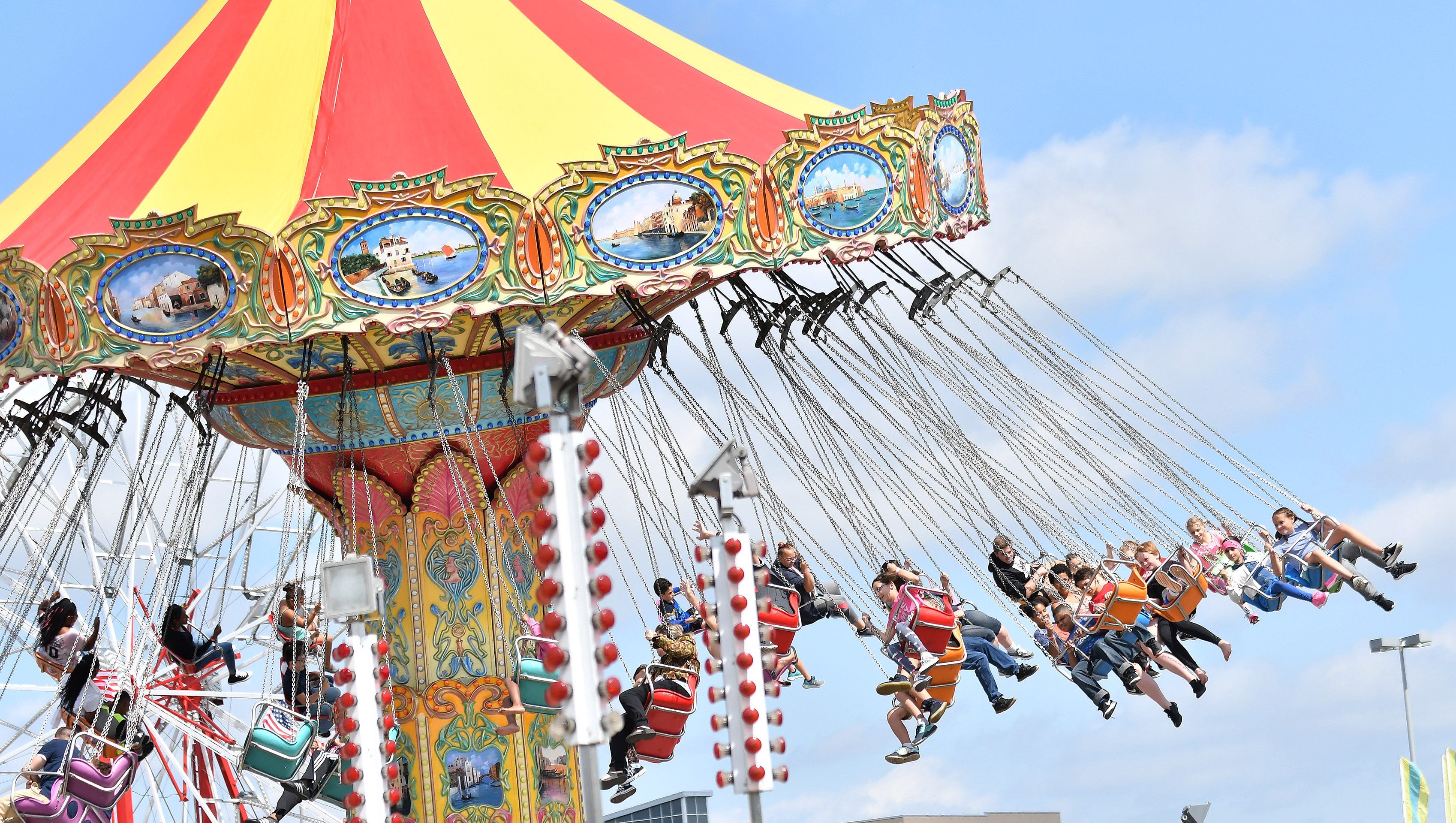 People ride the flying chairs at the Michigan State Fair.