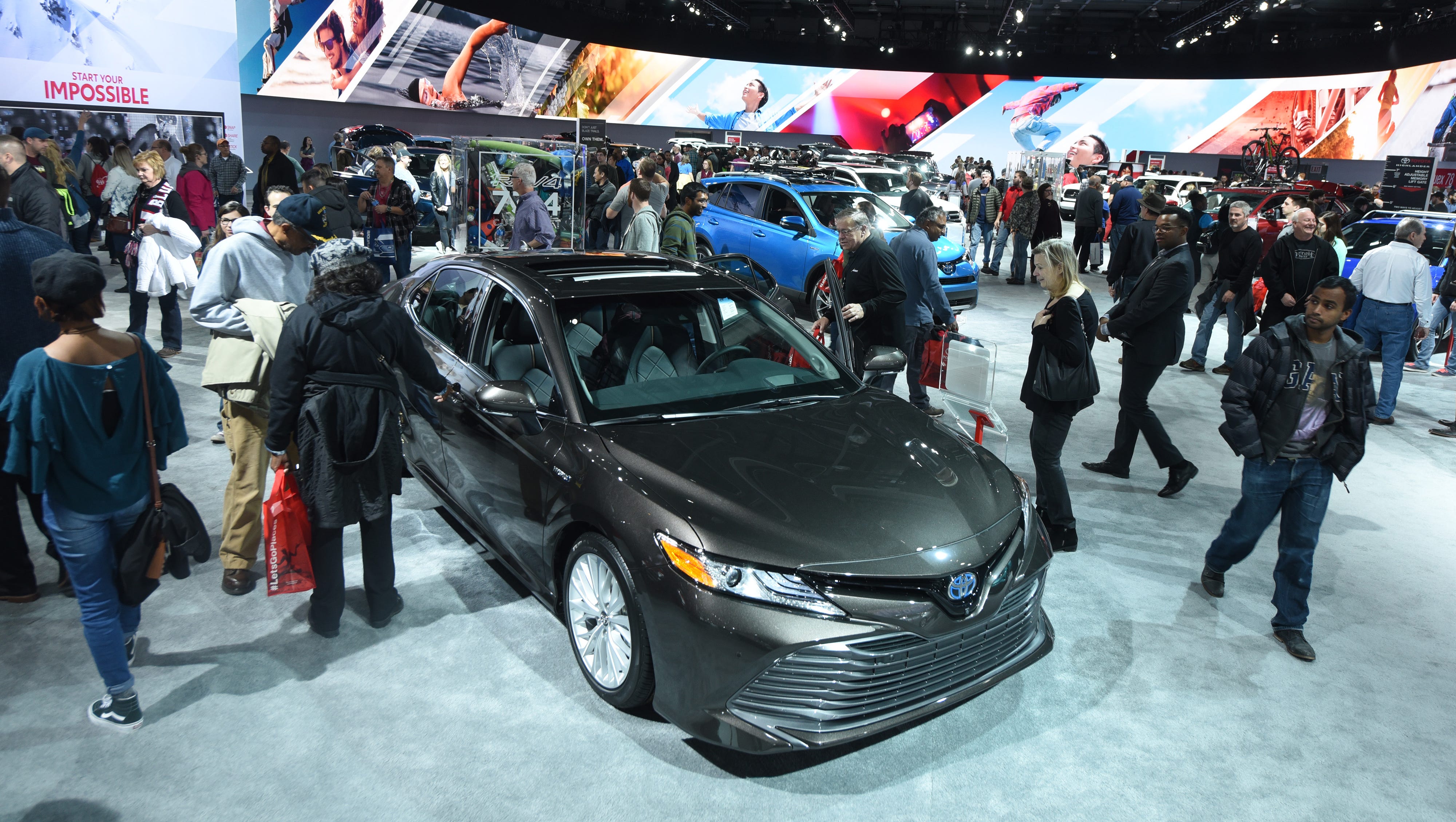 People surround the Toyota 2018 Camry Hybrid on Saturday January 20, 2018 .