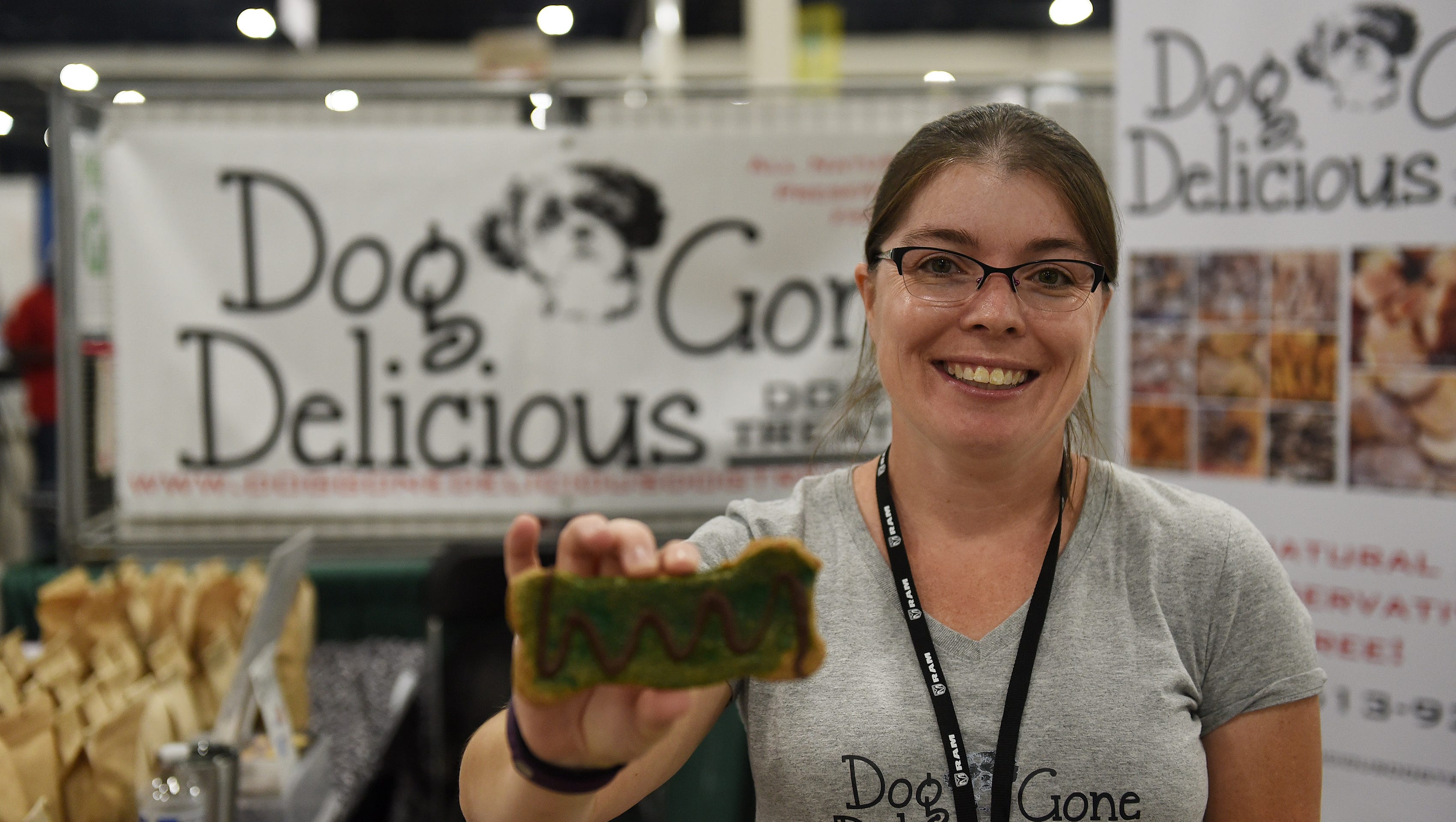 Dawn Sommers, owner of Dog Gone Delicious Dog Treats, shows off one of her peanut butter dog bones at her booth.
