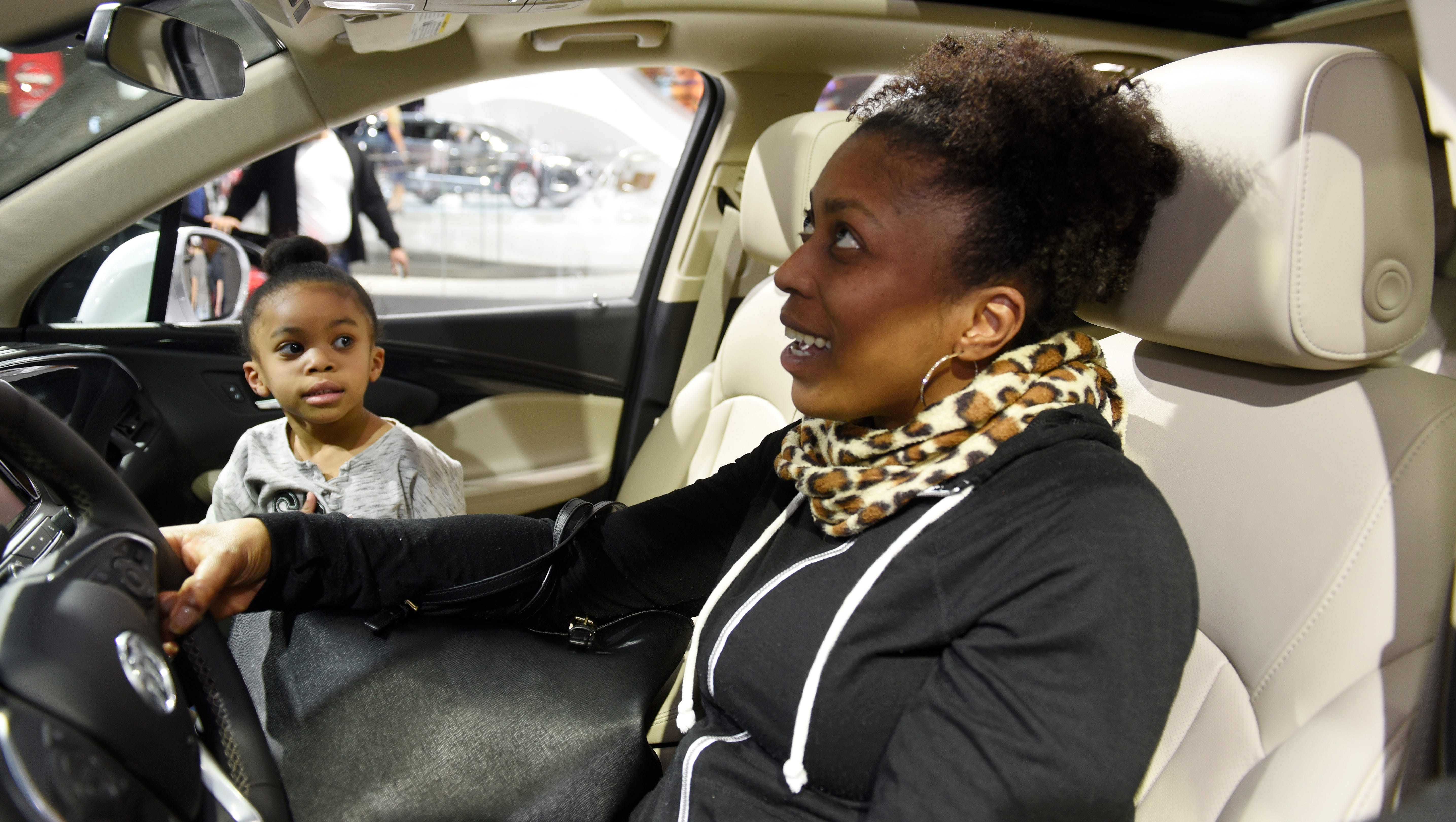 Rhonda Walker, 42, of Sterling Heights and her 5-year-old daughter Riley Walker check out the interior of the 2018 Buick Envision.