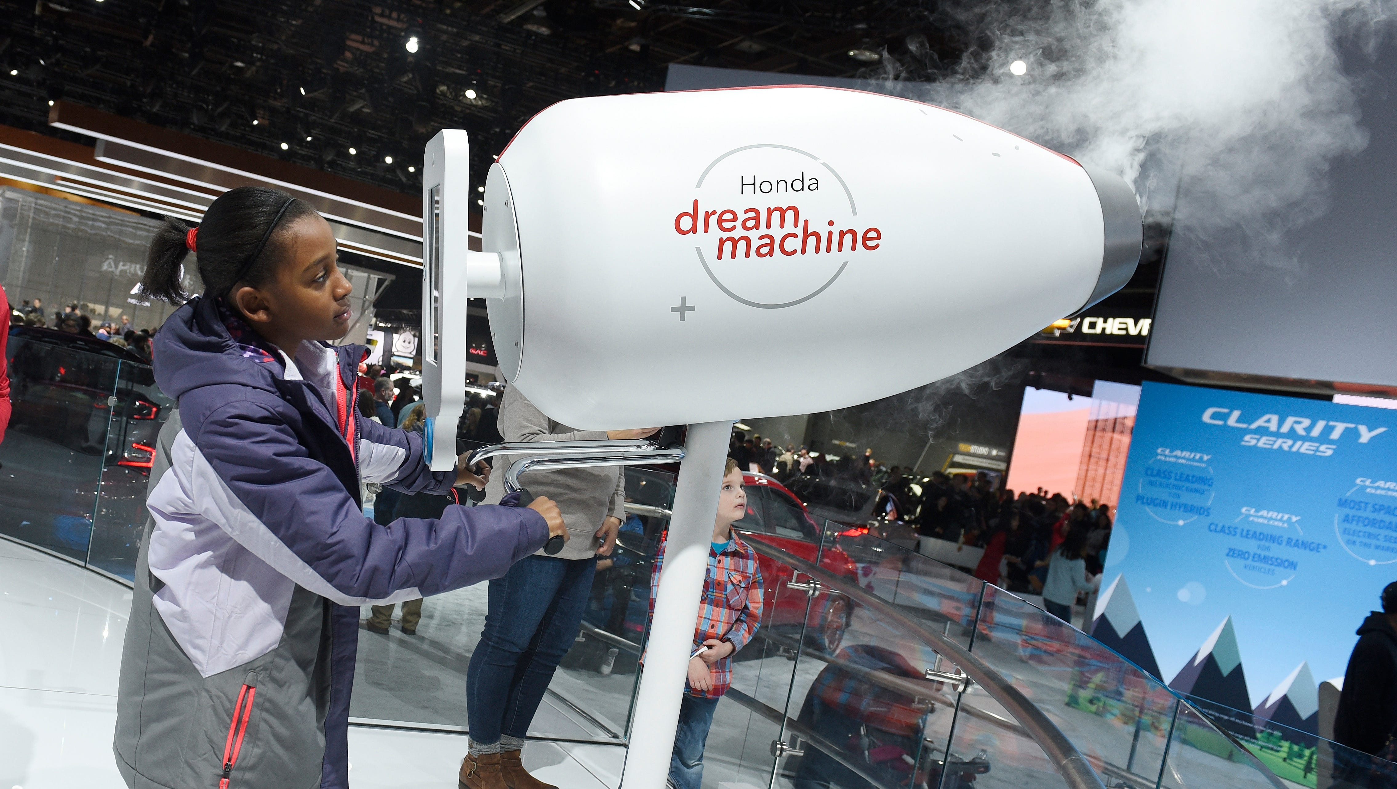 Zariah Pulliam, 10, of Dowagiac, Michigan, takes a digital photo of herself using the Honda dream machine.