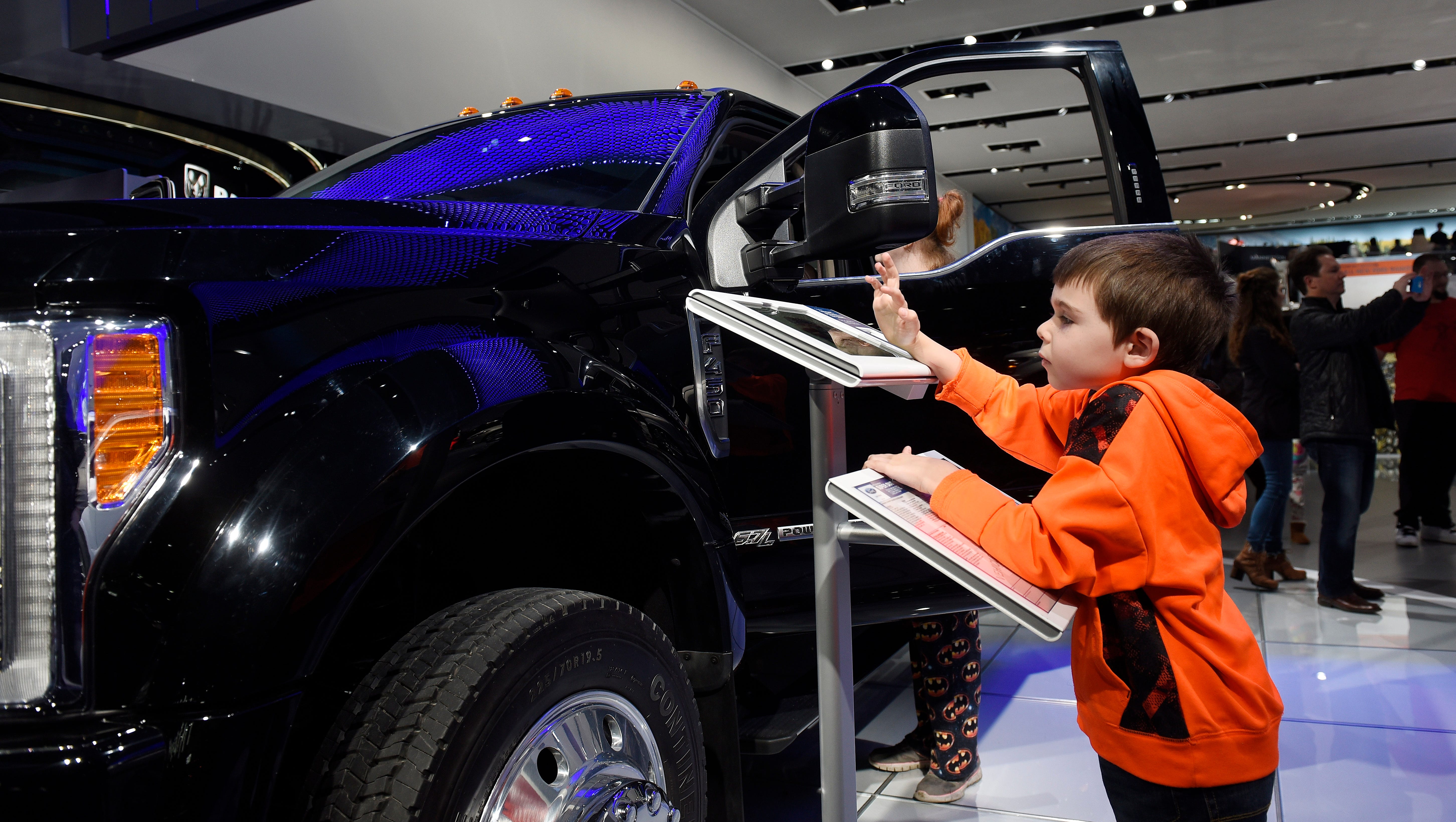 Daniel Pershyn-Tikh, 6, of Bloomfield Hills, interacts with the 2018 Ford F450 Super Duty electronic information wheel stand.