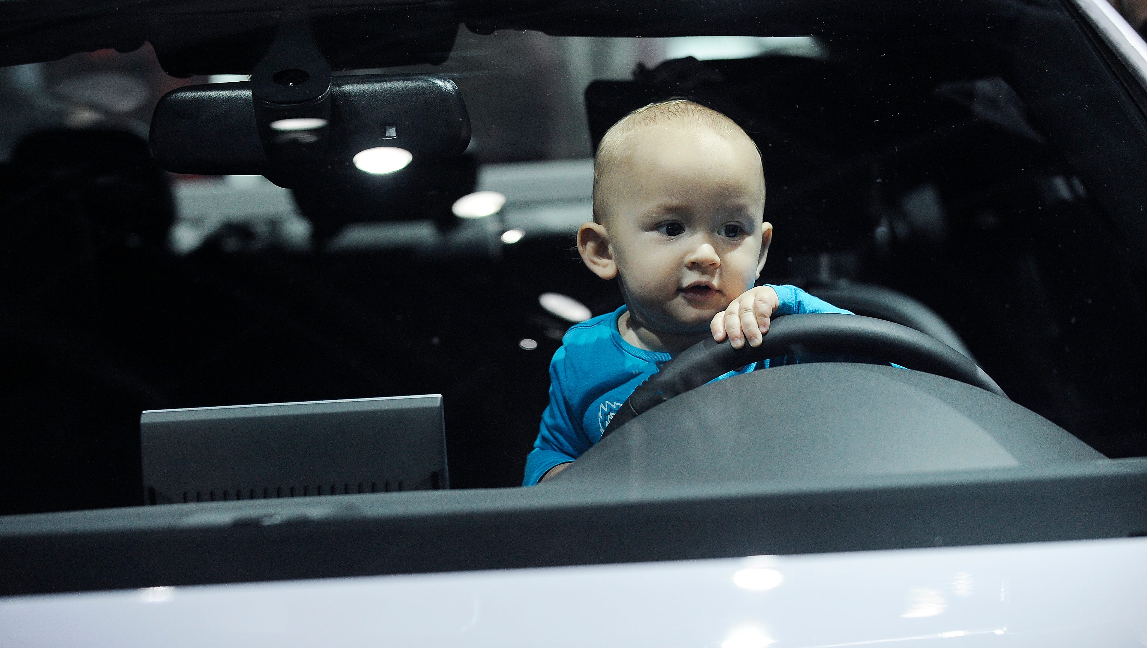 Aron Kleiman, 1, of Toronto, Ontario, sits behind the wheel of the 2018 Audi A6 Quattro at Cobo Center on Sunday, January 21, 2018, for the second public day for the North American International Auto Show.