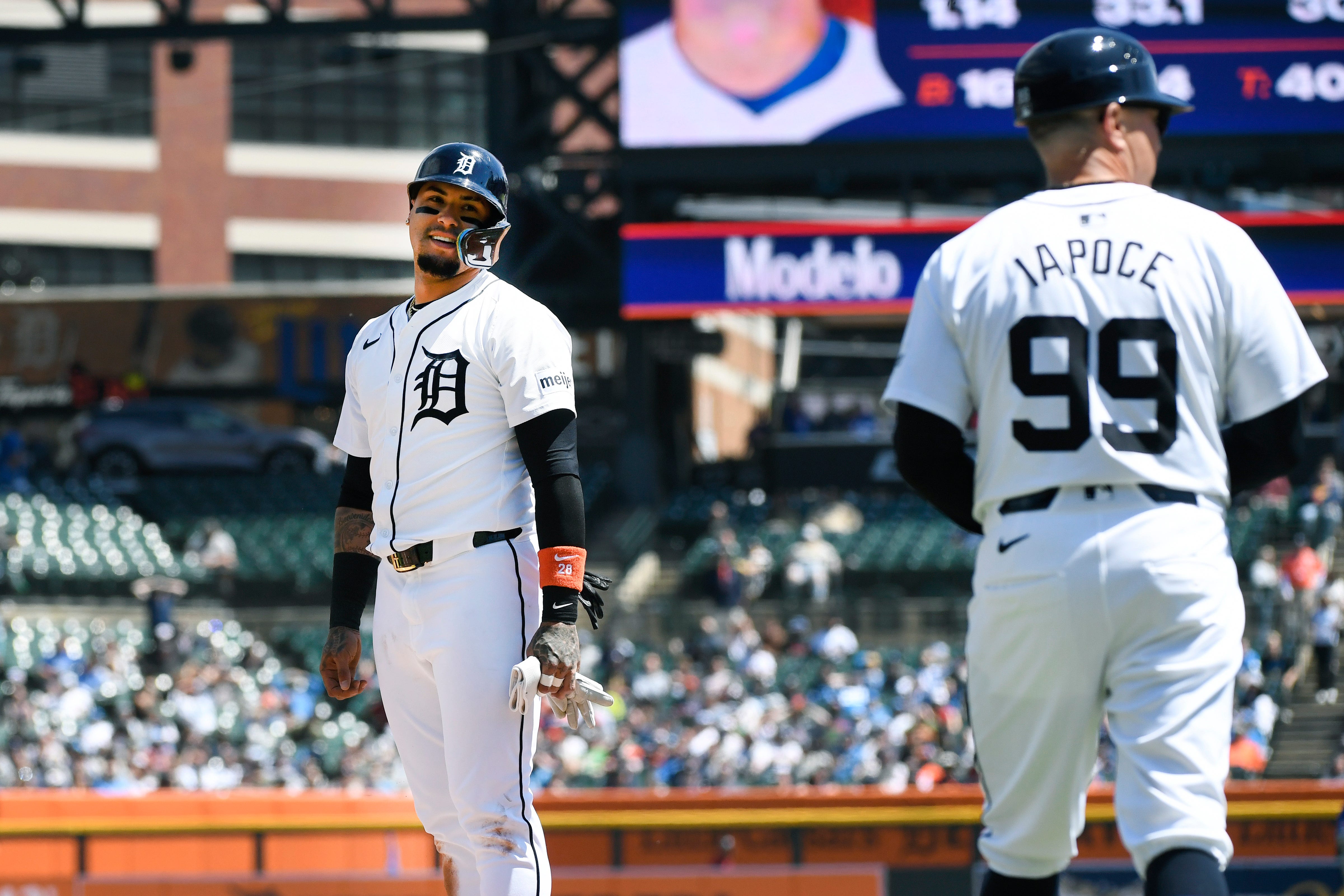 Tigers' Javier Báez, left, looks at first base coach Anthony Iapoce after he was thrown out at first base by Royals right fielder Adam Frazier to complete a double play in the third inning.