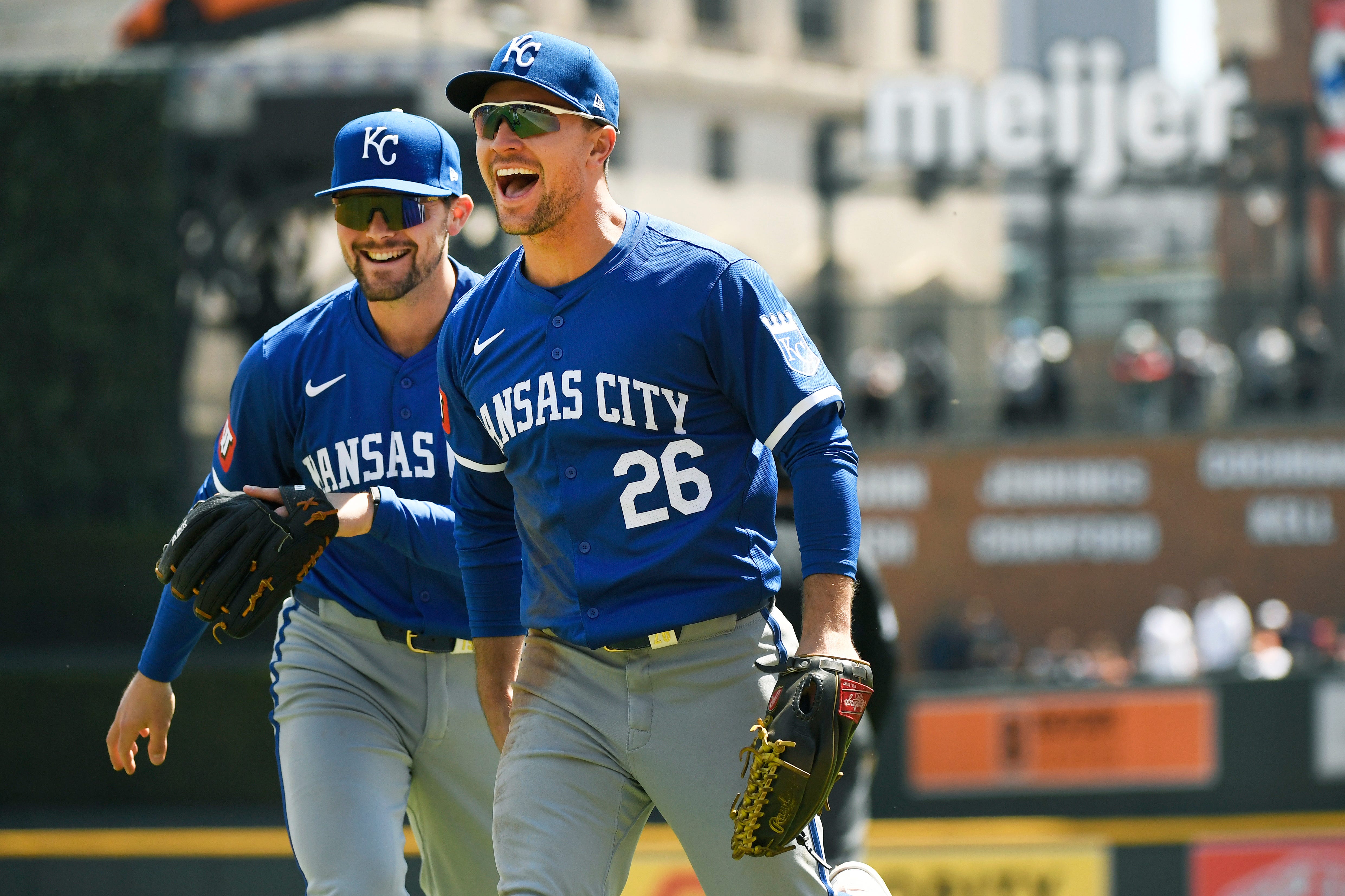 Royals right fielder Adam Frazier, front, is congratulated by Michael Massey after Frazier made a double play to end the third inning.