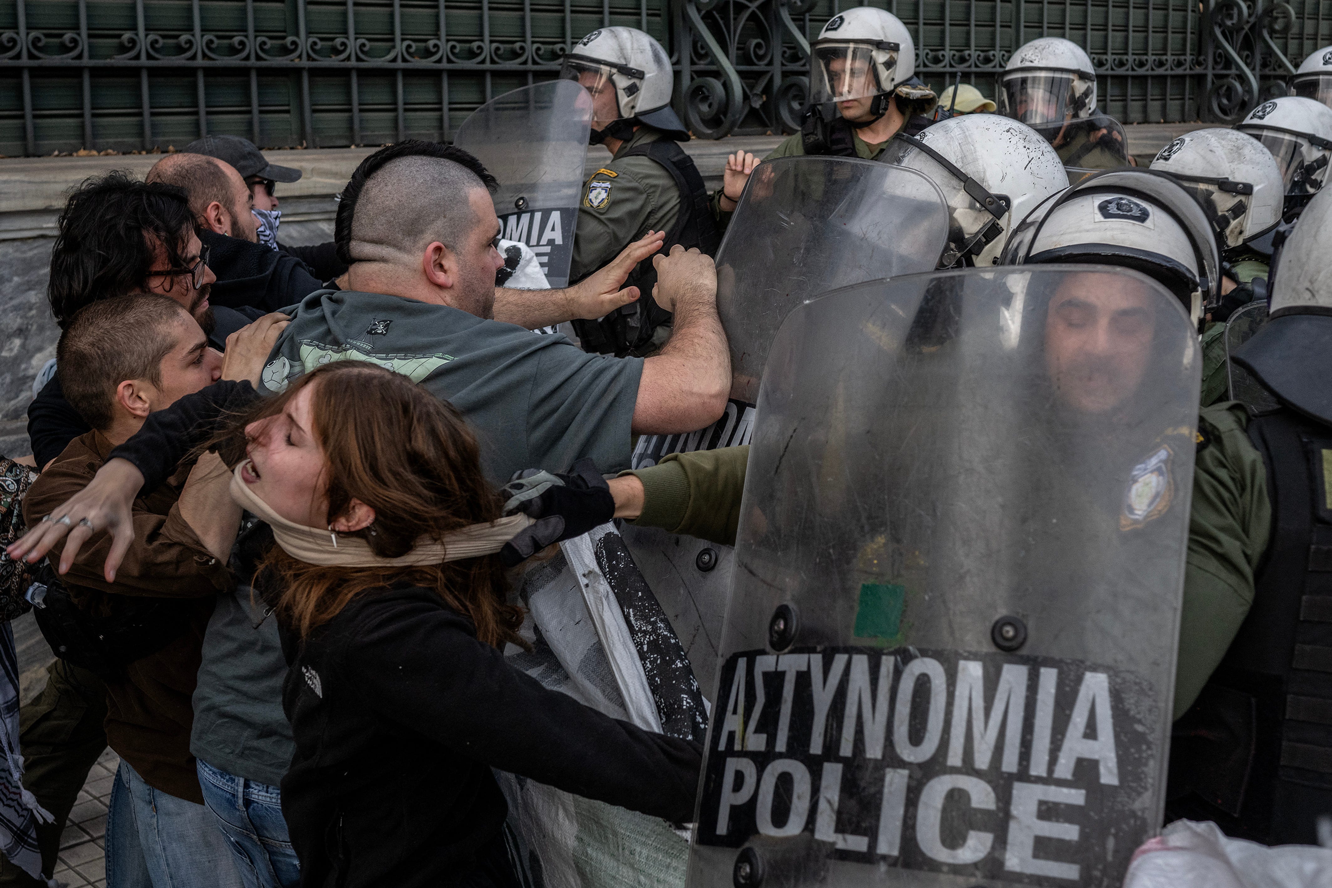 Riot police officers clash with pro-Palestinian protesters during a rally in support of Palestinians, outside the Egyptian Embassy in Athens on May 7, 2024.