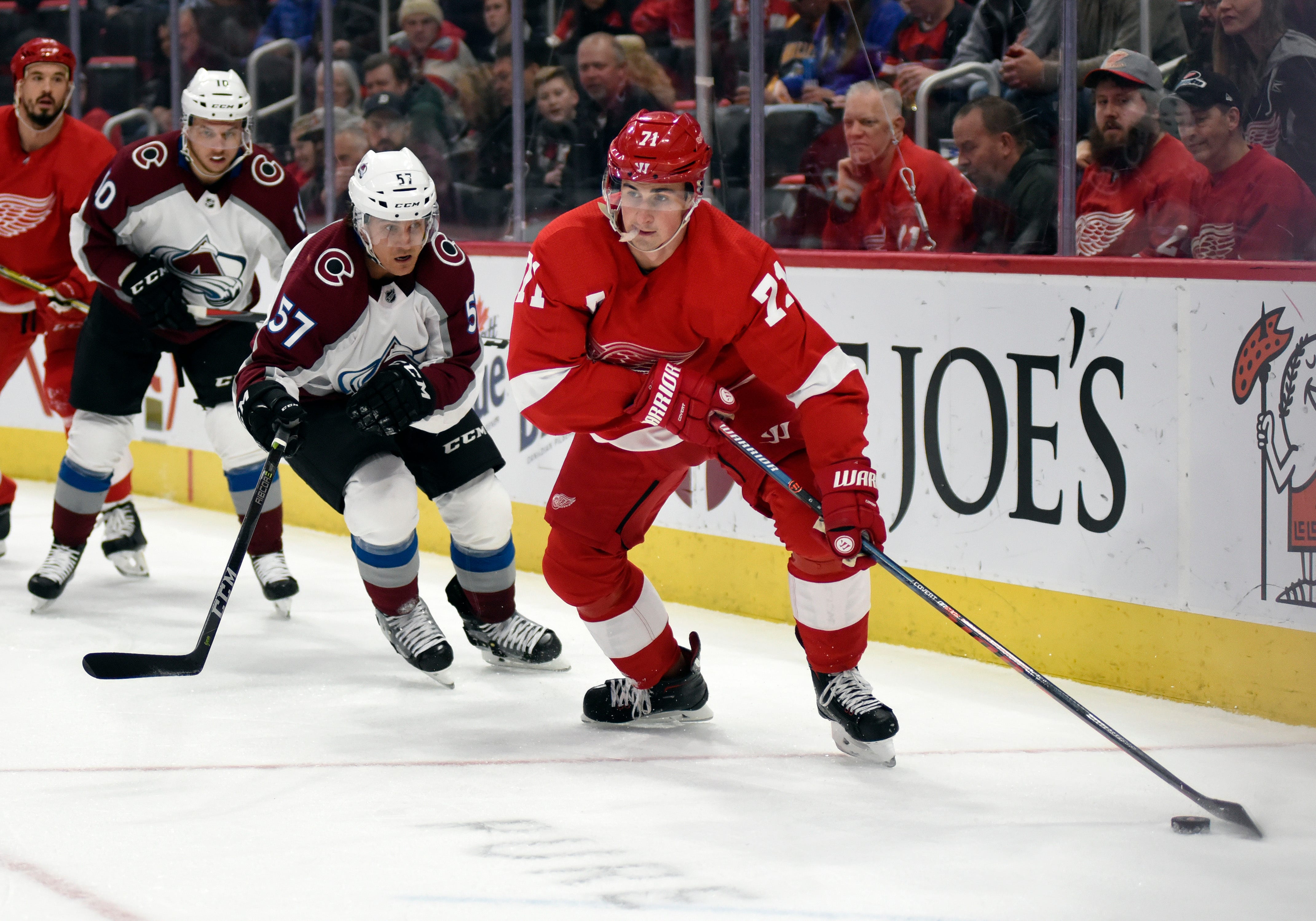 Detroit Red Wings center Dylan Larkin, right, moves the puck away from Colorado Avalanche left wing Gabriel Bourque in the first period of the game in Detroit, Sunday, Dec. 2, 2018. The Red Wings lost, 2-0.