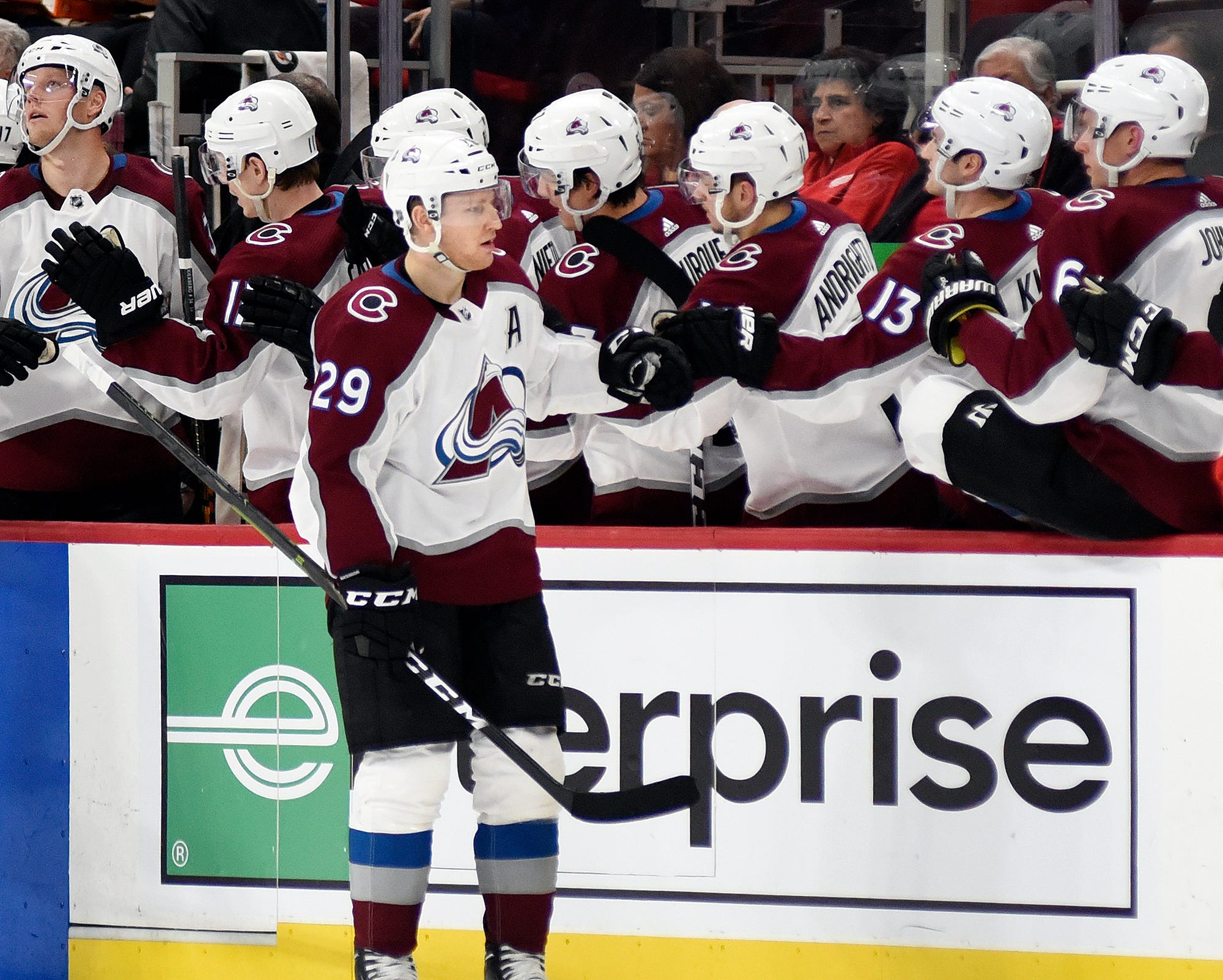 Avalanche center Nathan MacKinnon (29) is congratulated by teammates after scoring against the Red Wings during the second period.