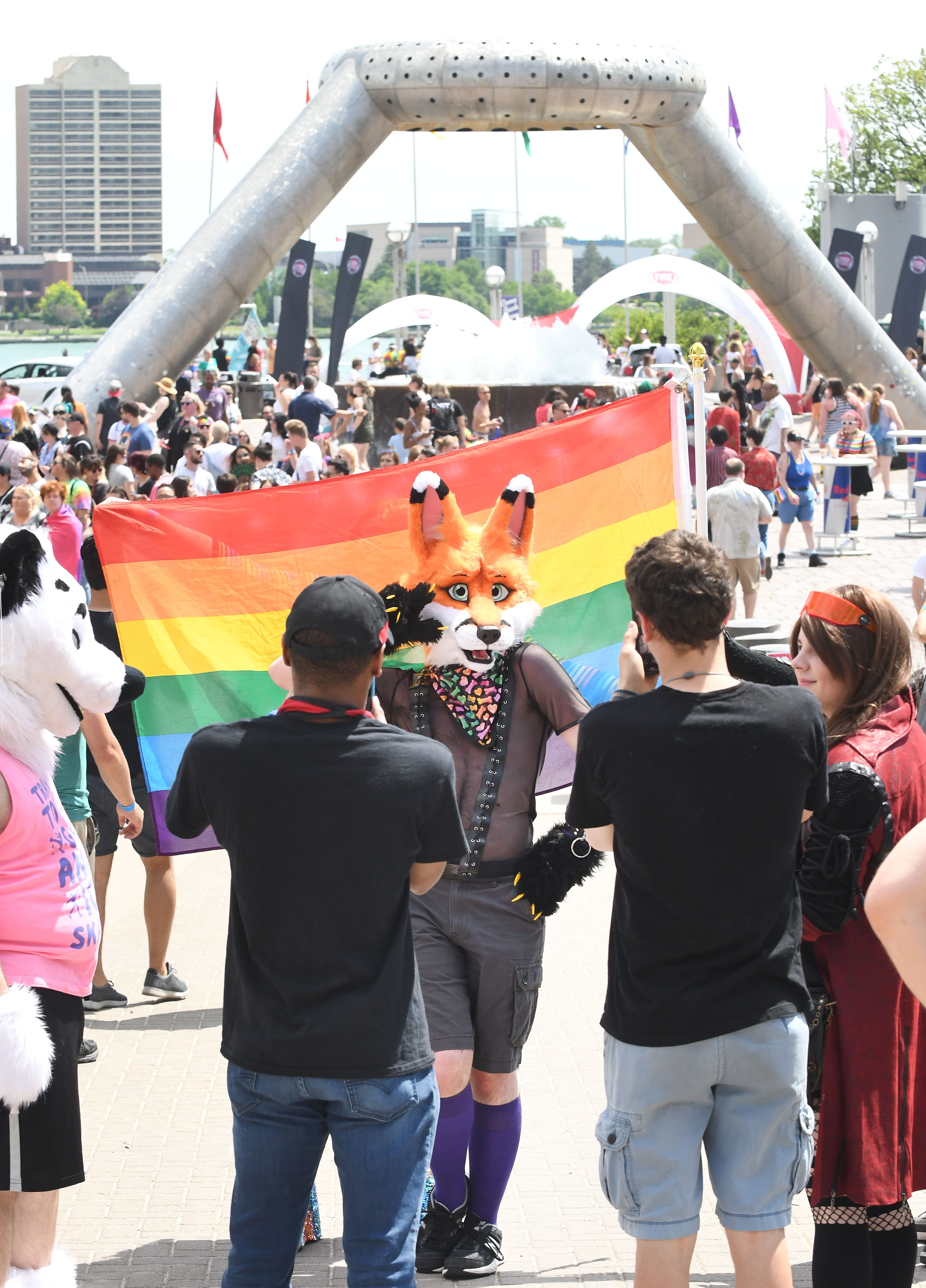 A furry fox poses for pictures with visitors to the Motor City Pride festival in Hart Plaza.