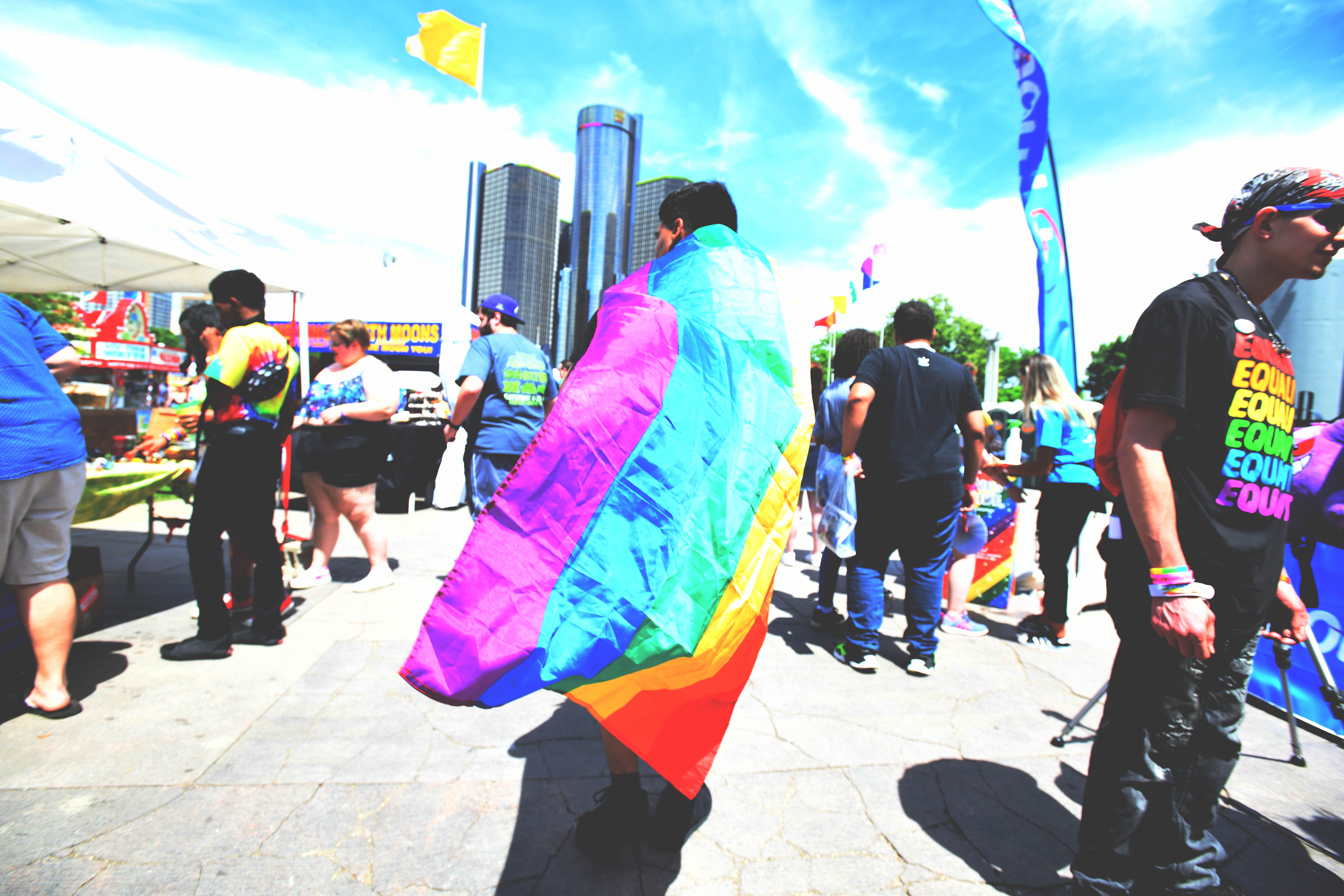 A rainbow caped figure makes his way through the crowd at the Motor City Pride festival in Hart Plaza in Detroit.