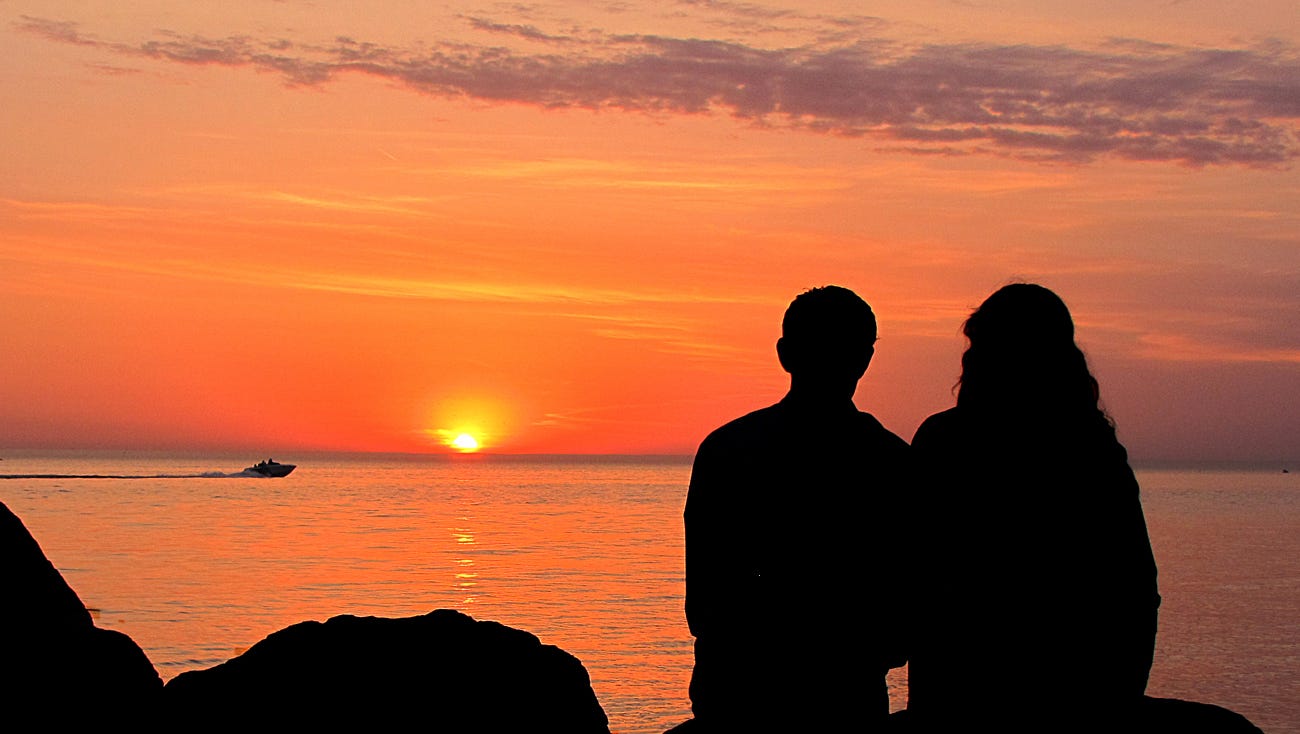 "The sun was setting over Lake Michigan near Holland when I noticed the couple in the photo," said Phillip DePetro of Holland.  "I took the silhouette shot, the sunset as a backlight.  I imagine this is a story in the lives of many couples in Michigan -- romantic evenings watching sunsets on the shores of a beautiful lake."