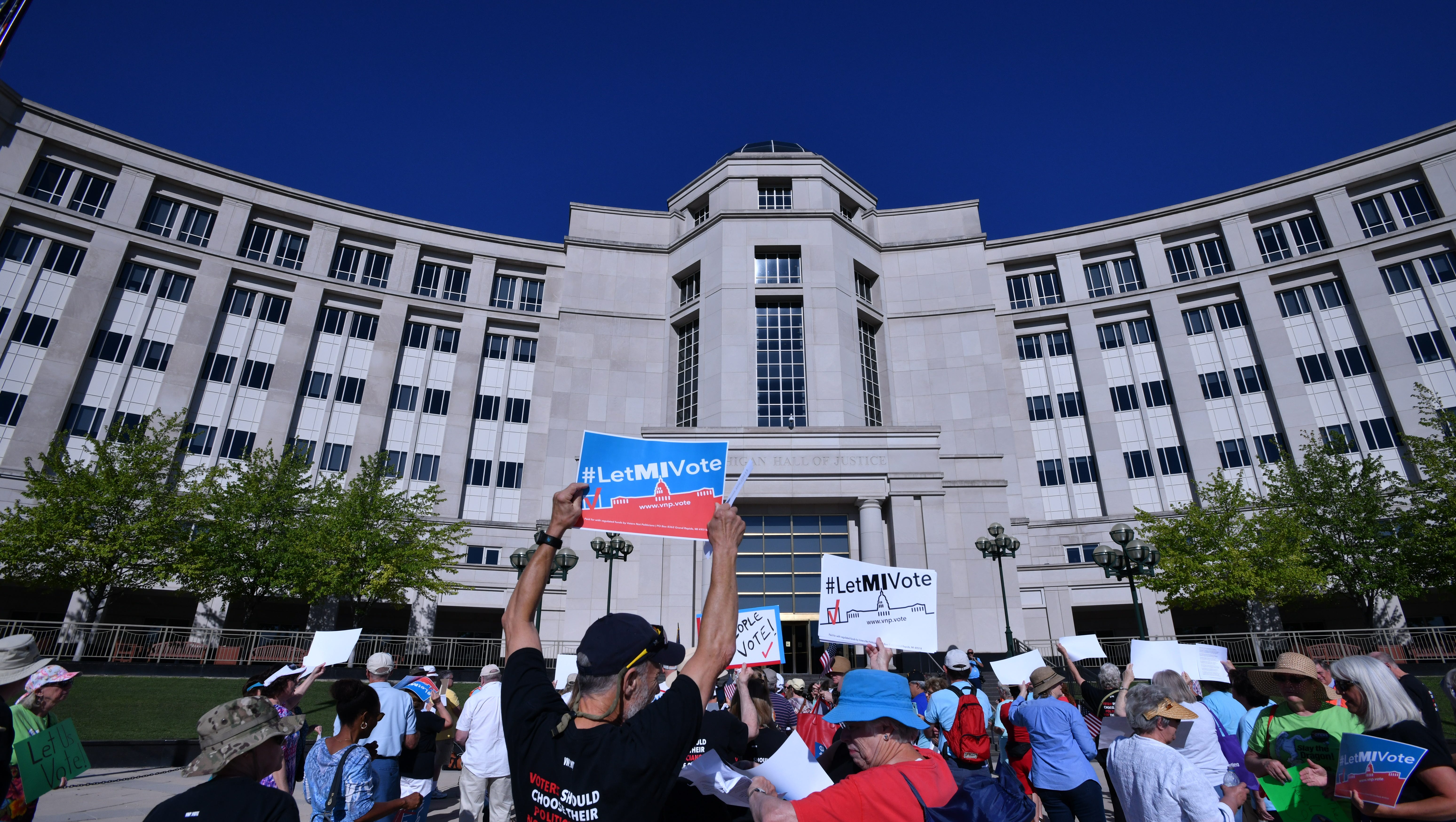 Supporters of an initiative to create an independent redistricting commission gather outside the Michigan Supreme Court on July 18, 2018
