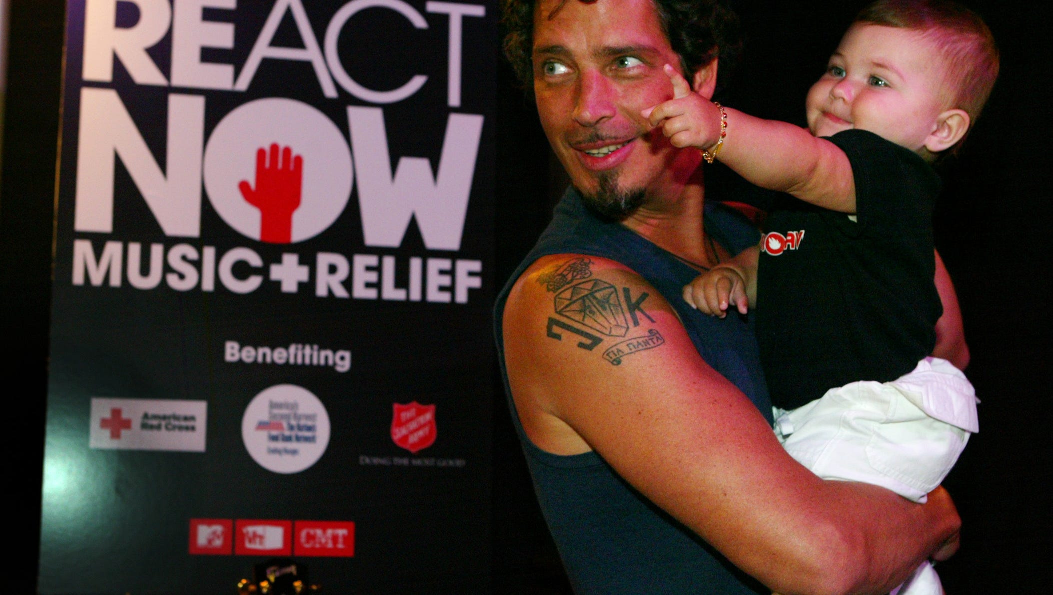 Chris Cornell holds his 11 1/2 month old daughter Toni backstage after he performed during the "ReAct Now: Music & Relief" TV special, a fund-raiser for the victims of Hurricane Katrina,  Sept. 10, 2005, in Los Angeles.