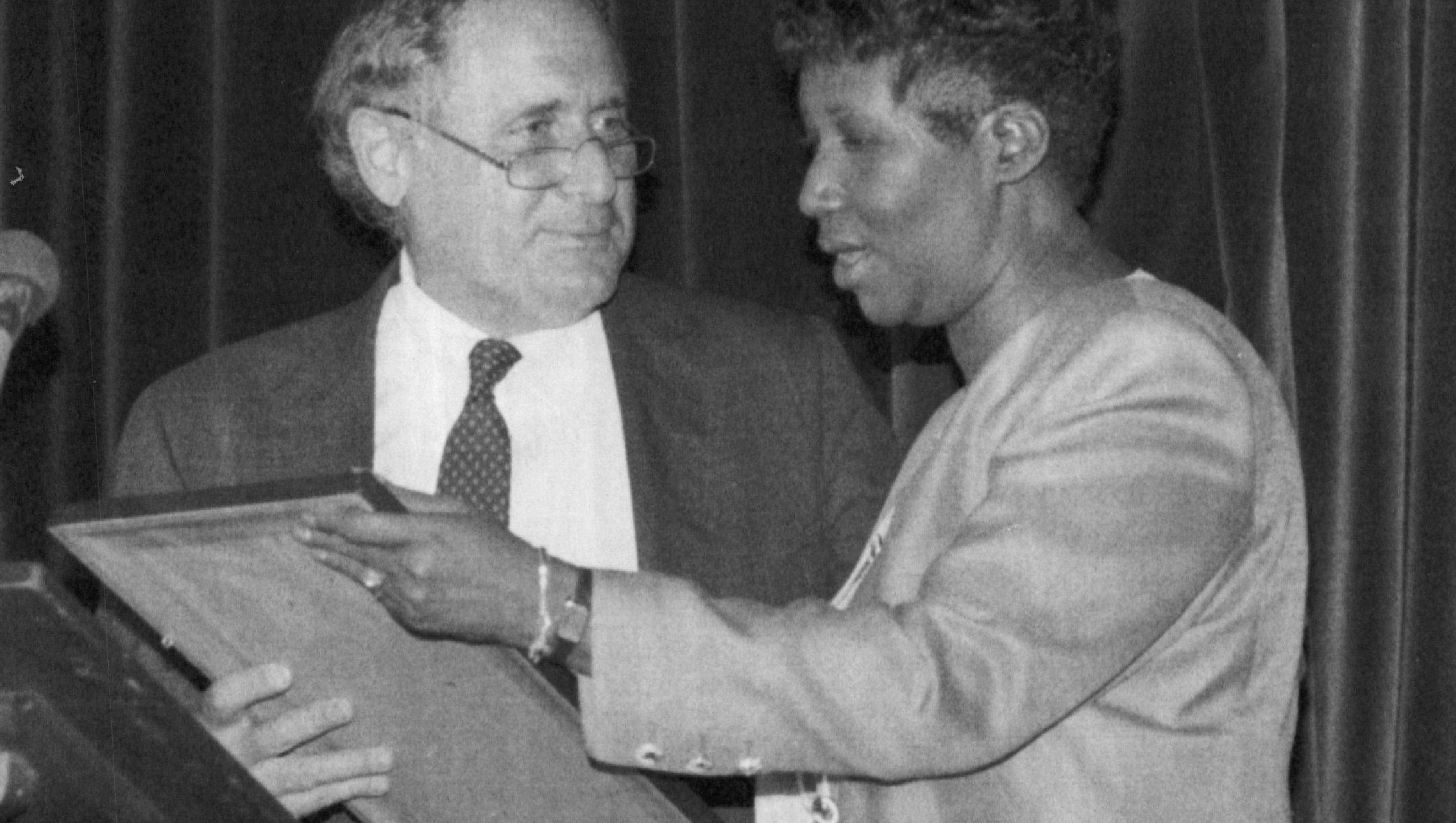 Sen. Carl Levin presents a plaque to Aretha Franklin honoring her for  contributions to American music and her efforts to combat drunk driving in 1989.