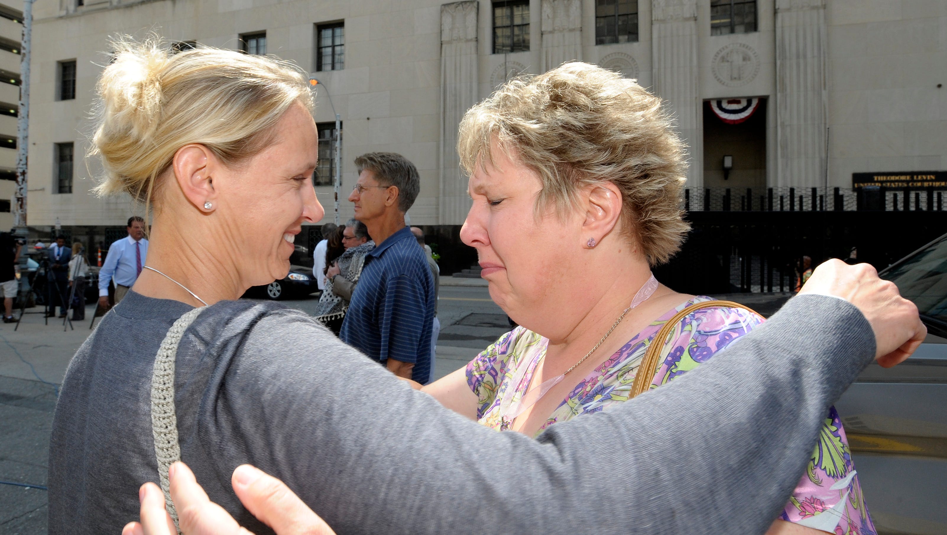 Janice Kosman, left, 46, of Washington, D.C., hugs her sister, Vickie Harrington, 55, of Ray Township. Their sister, Barbara Globie, of Dryden, died at the hand of Dr. Fata.