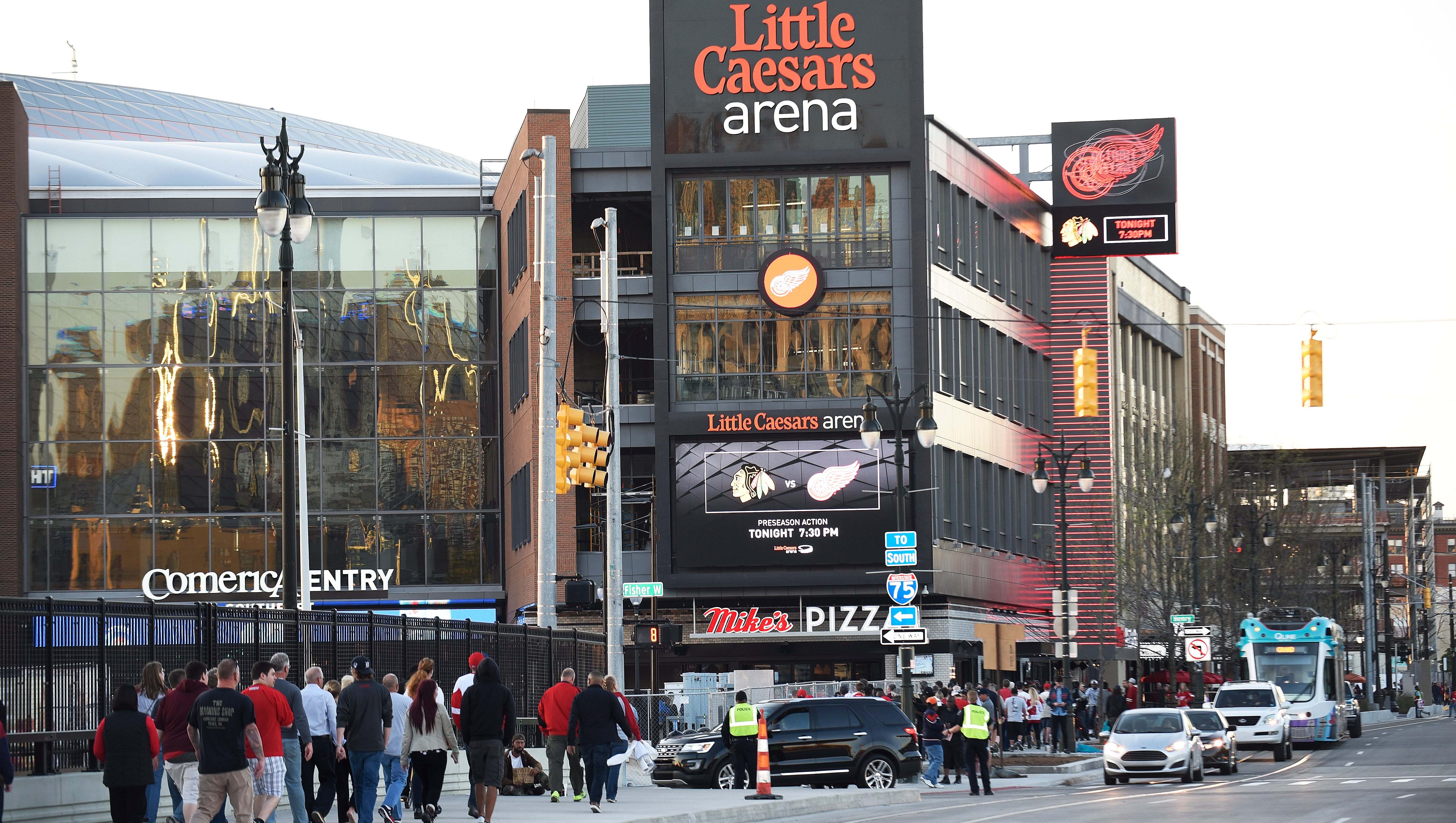 Traffic around Little Caesars arena includes foot, car and Qline.