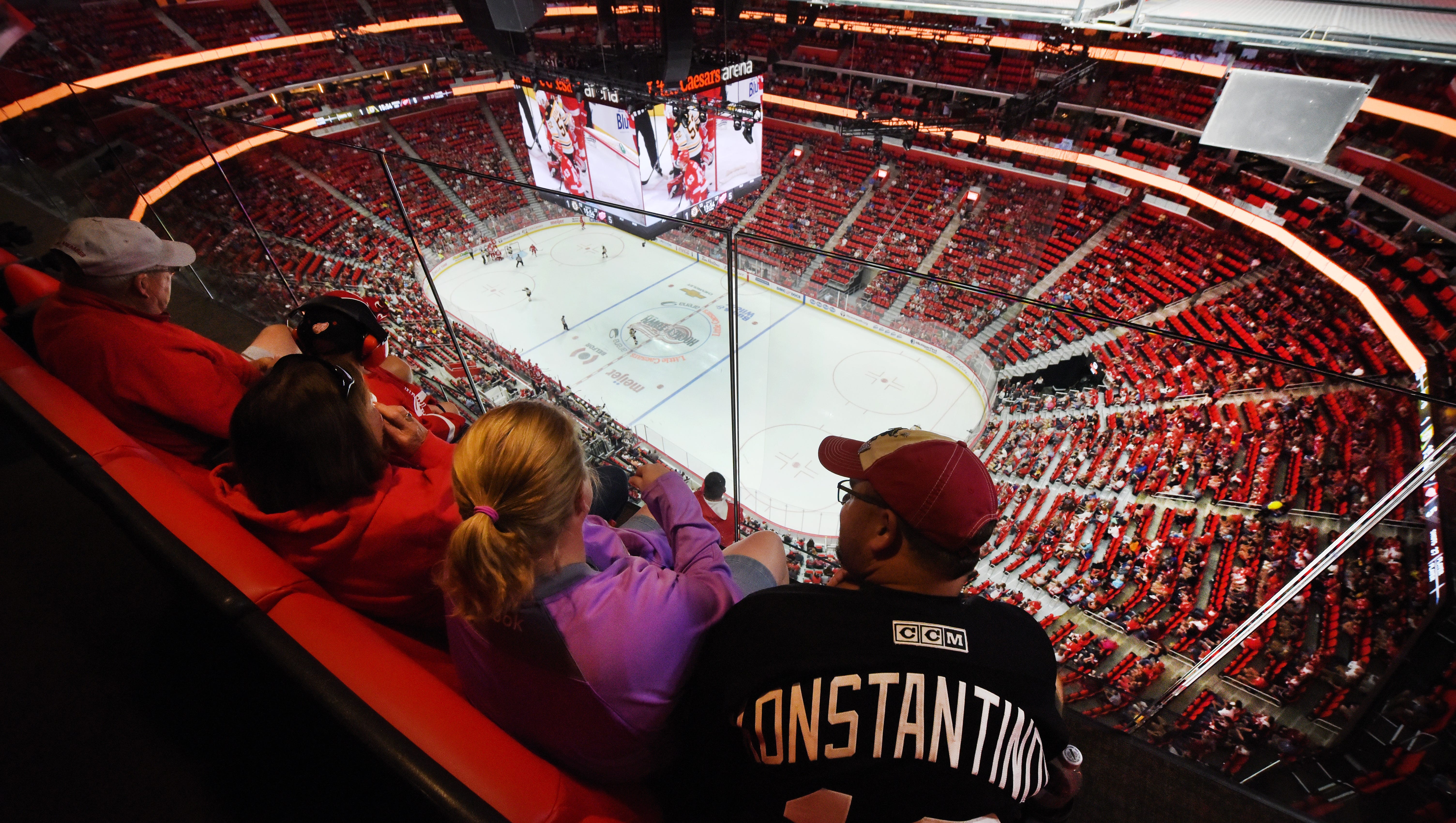 Red Wings fans sit along the glass in the West gondola high above the Little Caesars Arena ice.