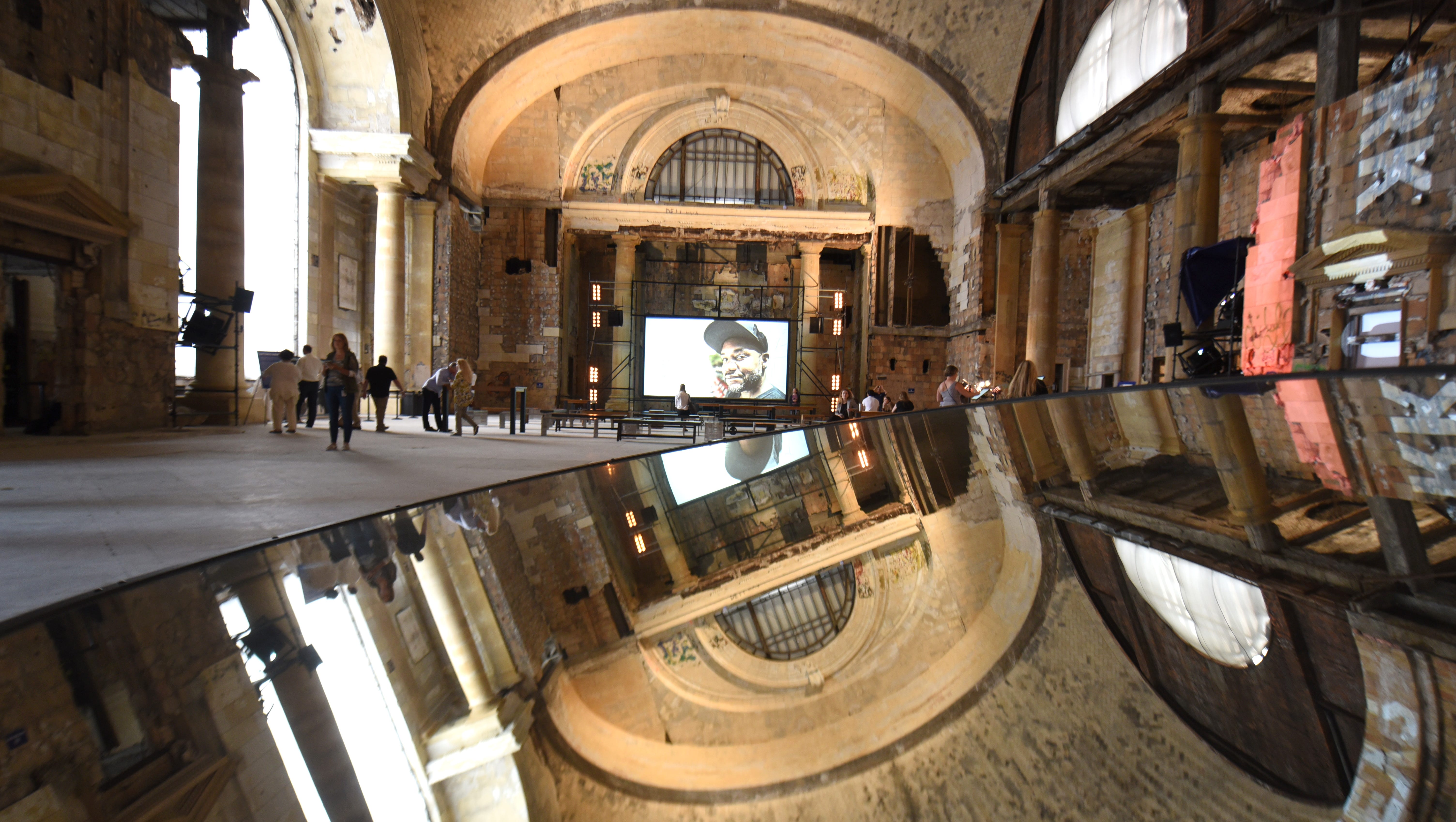 A mirror reflects the ceiling in the grand hall of the Michigan Central Train Depot on Friday. The Ford Motor Company hosted tours.