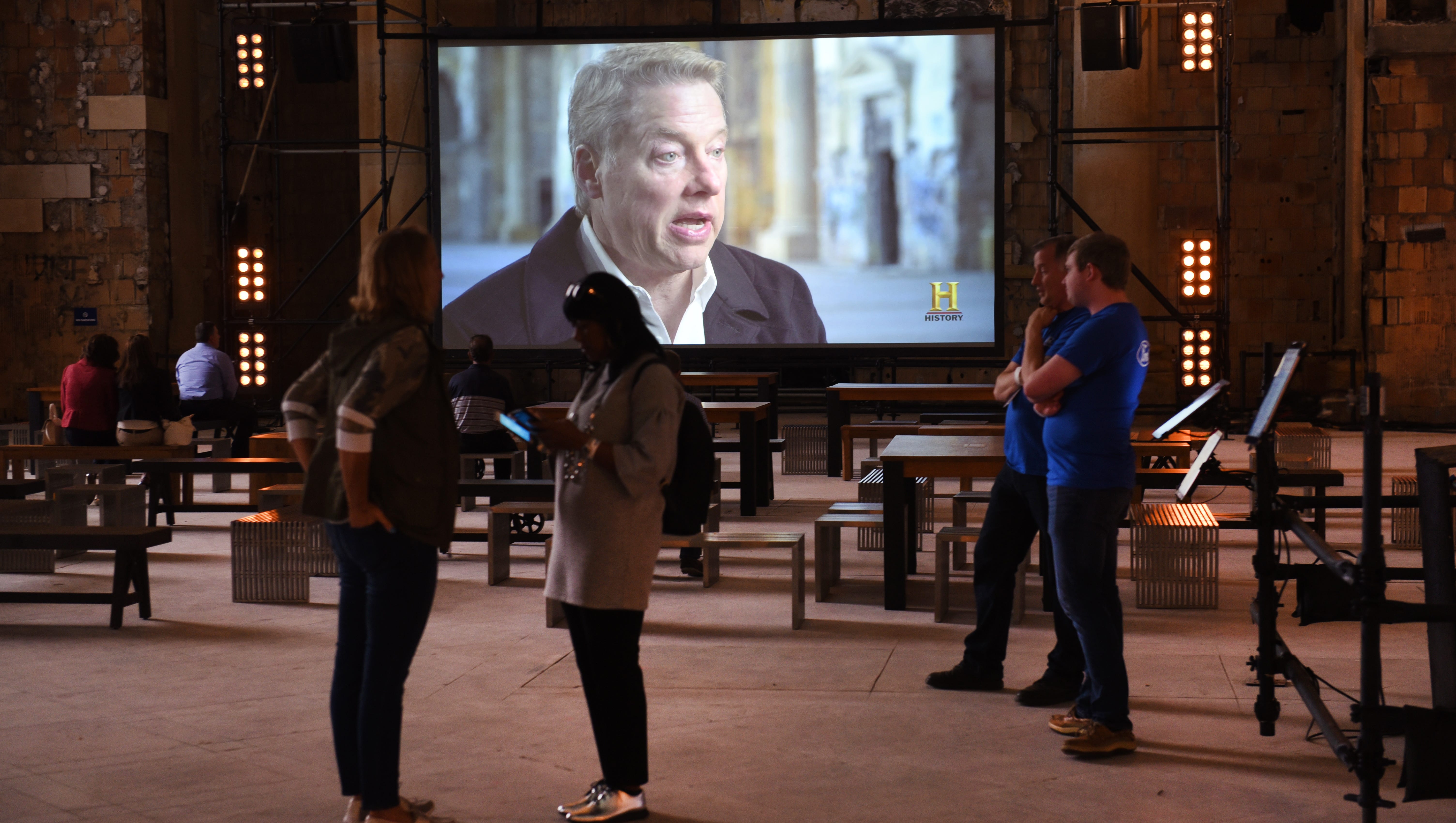 A video of Bill Ford Jr. is viewed in the grand hall of the Michigan Central Train Depot, as Ford Motor Company hosts an open house on Friday in Detroit.
