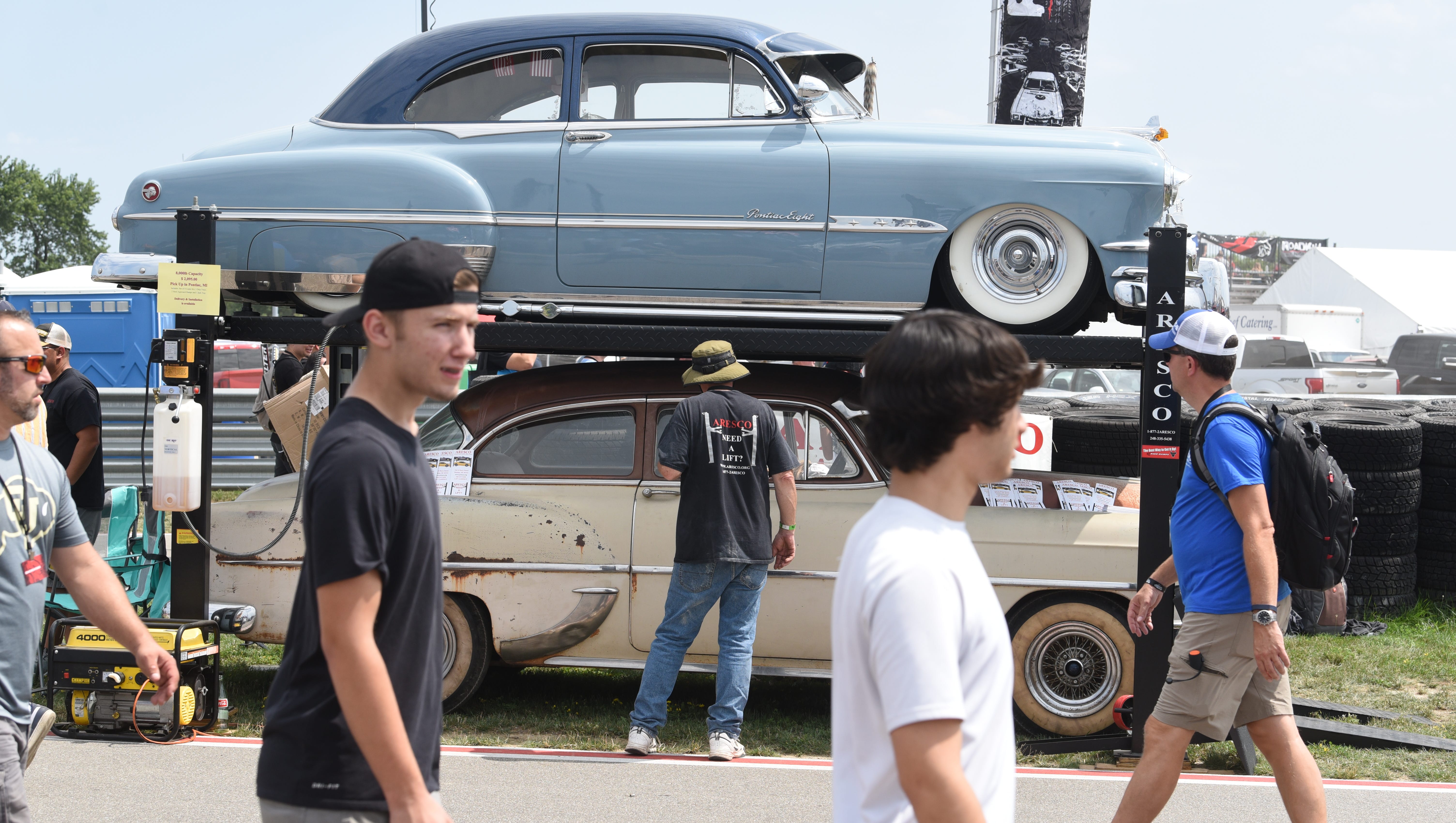 Fans look at classic Chevy cars stacked during the Roadkill Nights event in Pontiac on Saturday, August 11, 2018