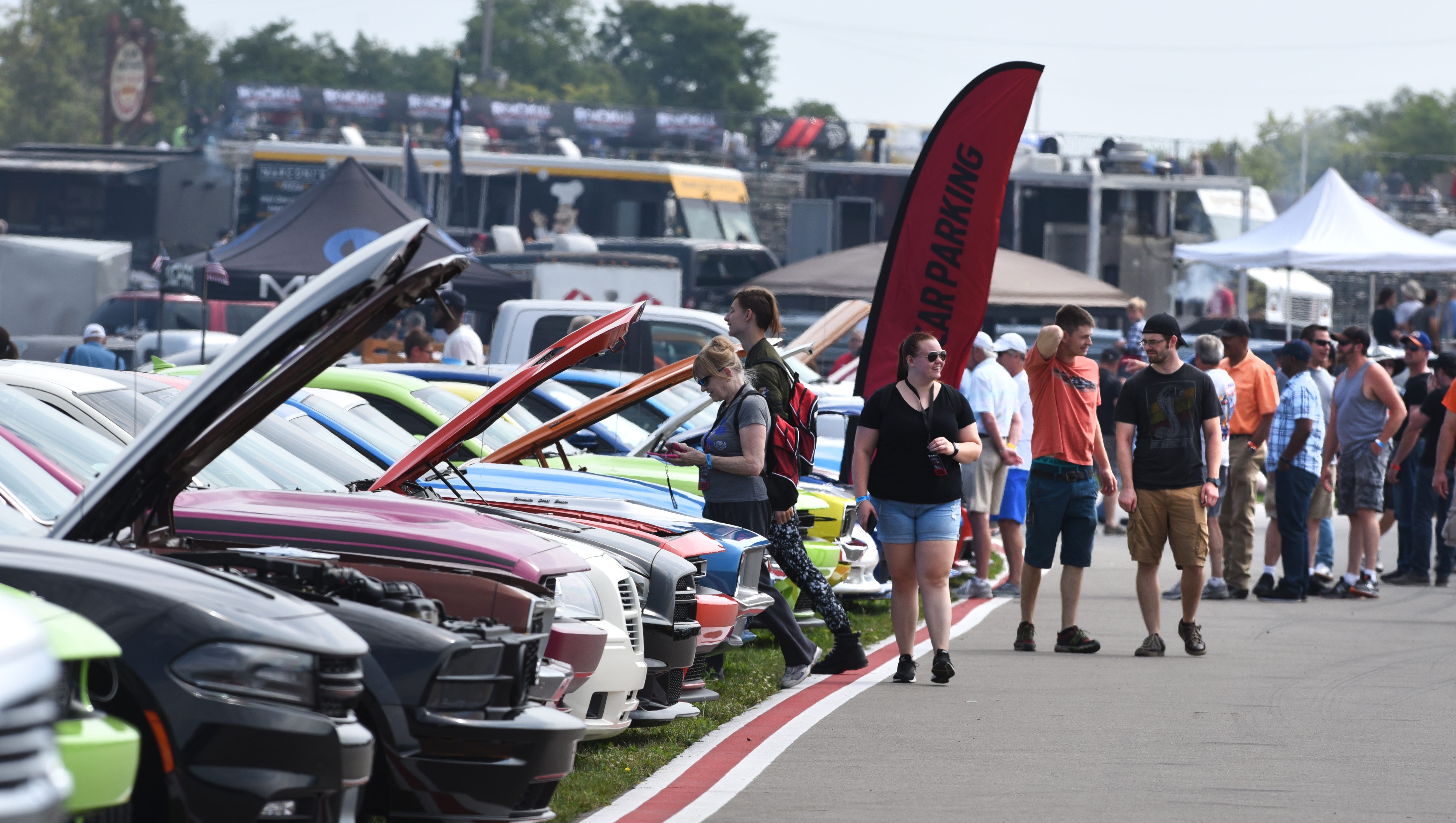 People enjoy the muscle cars on display during the Roadkill Nights event held at M1 Concourse in Pontiac.