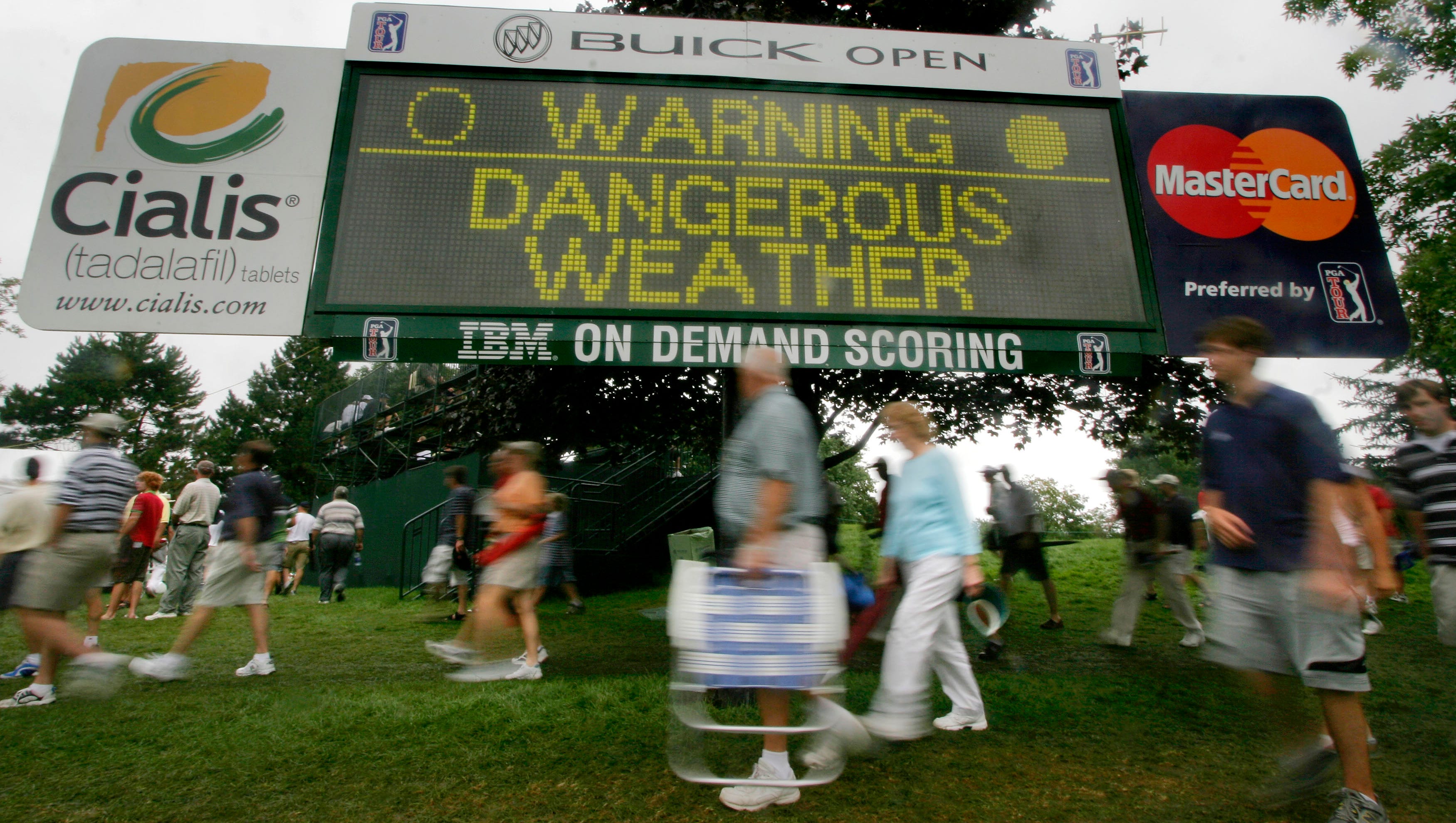 Golf fans evacuate Warwick Hill during a weather delay in 2006.