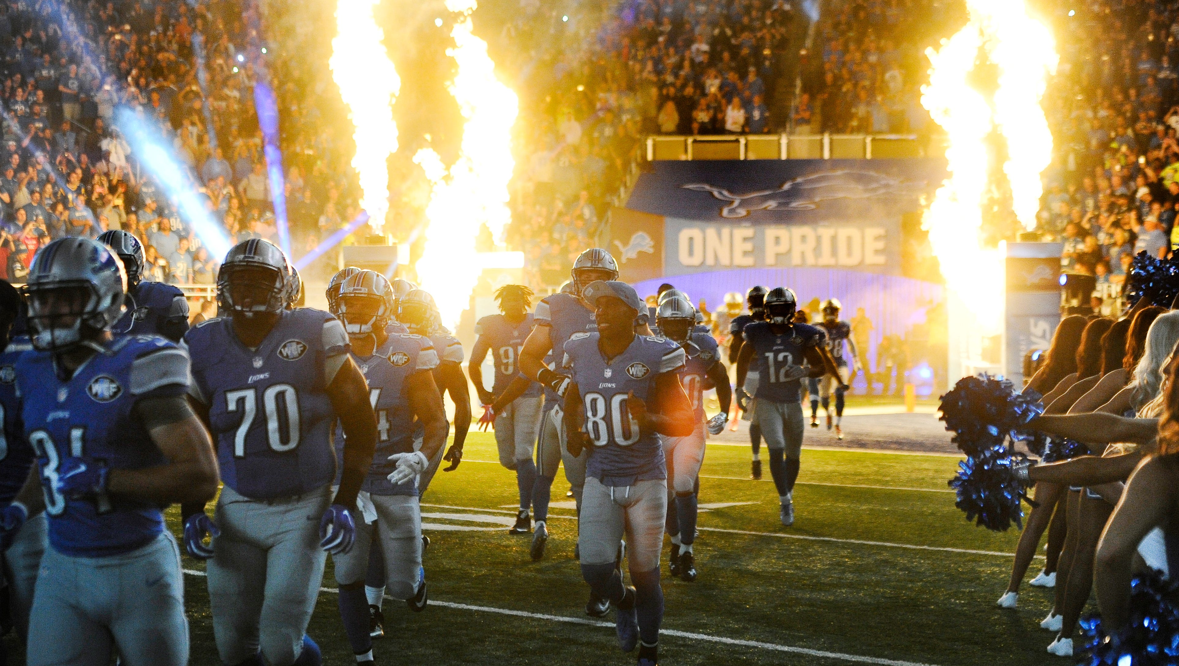 The Detroit Lions make their way onto the field before playing the Los Angeles Rams at Ford Field.