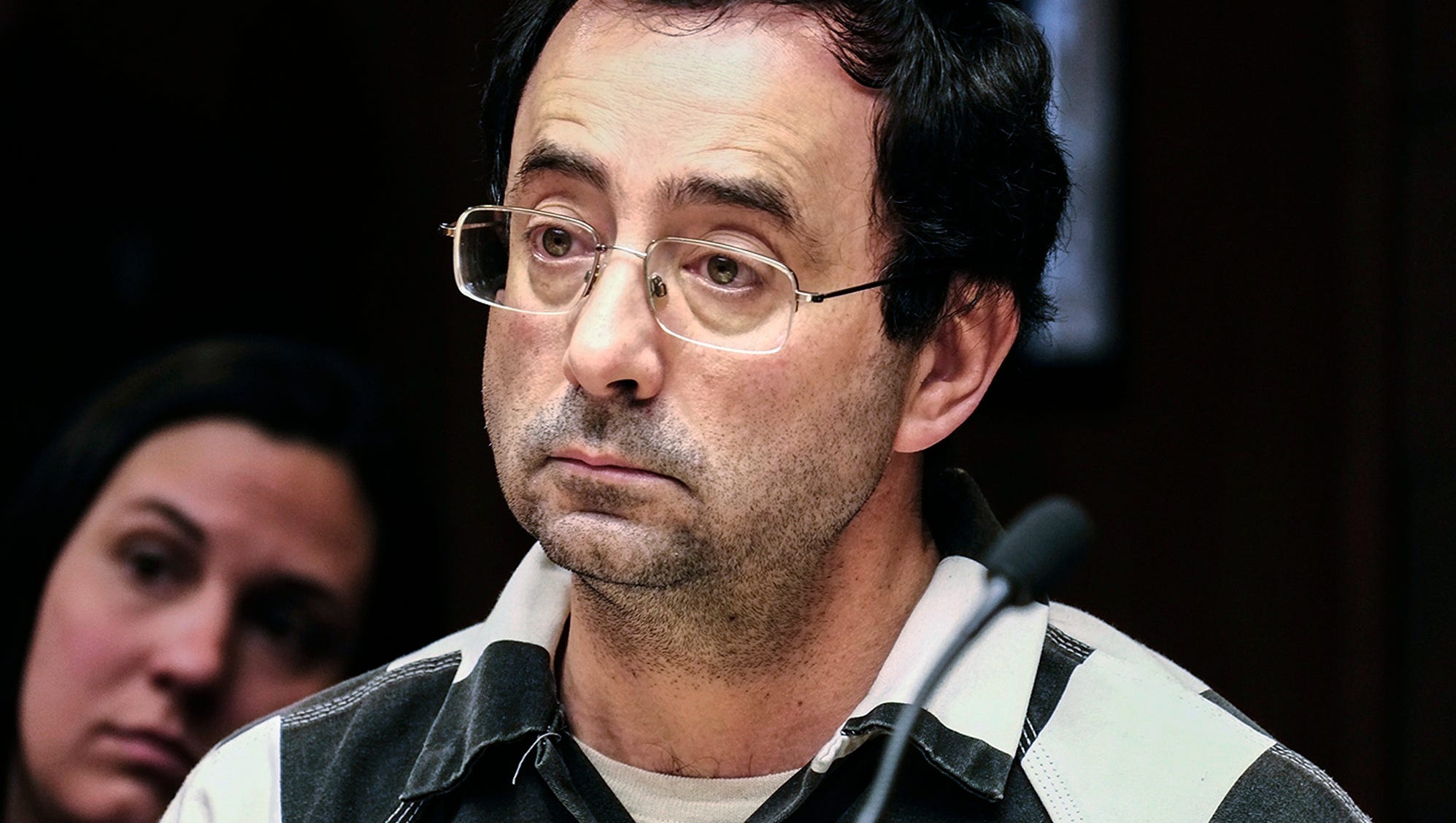 Dr. Larry Nassar listens to testimony of a witness during a preliminary hearing in Lansing, Michigan. Nassar, a former Michigan State University and USA Gymnastics sports doctor, is taking a step toward resolving one of four criminal cases against him.