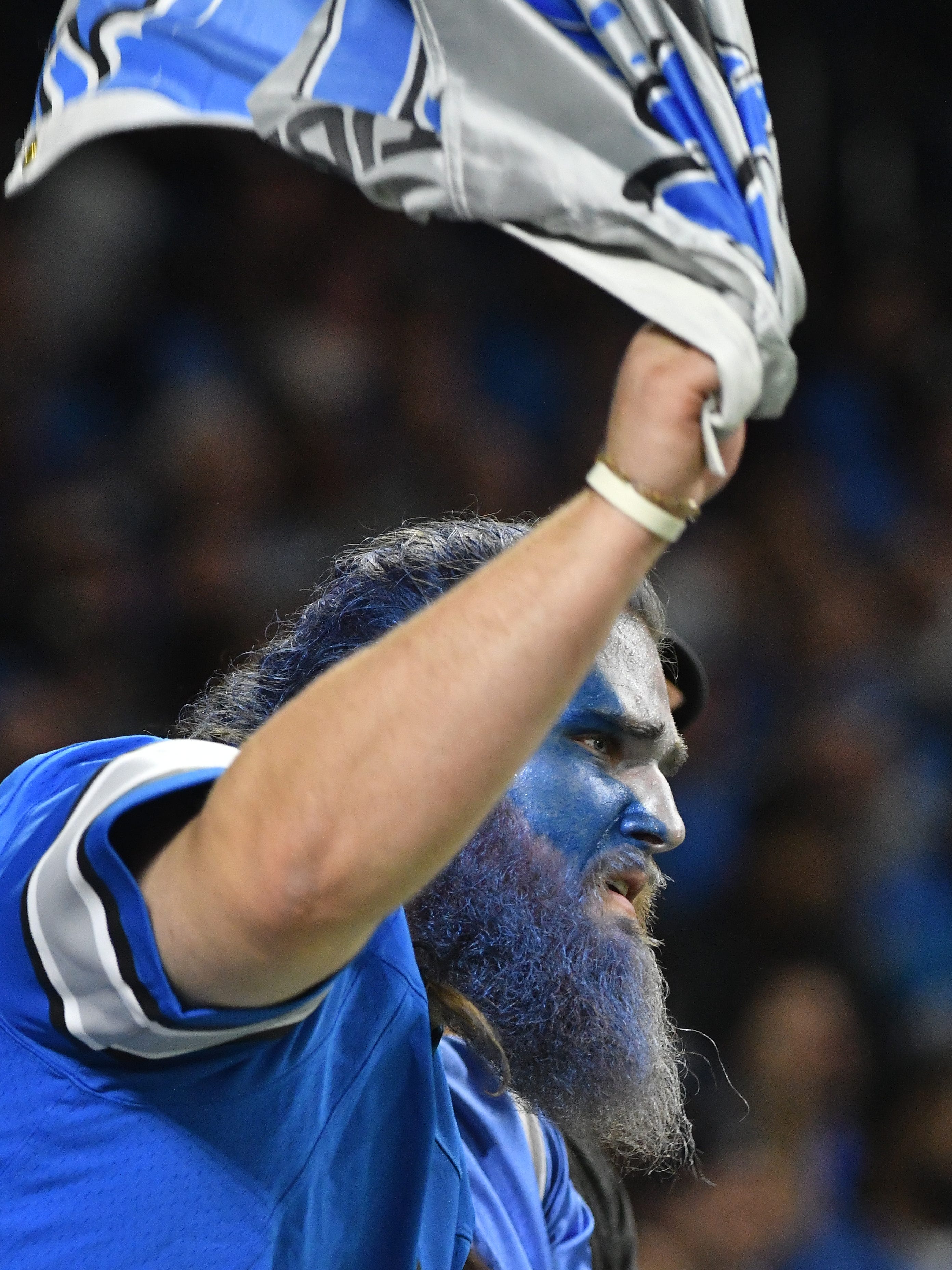 A Lions fan cheers on his team in the second half of the tight game.