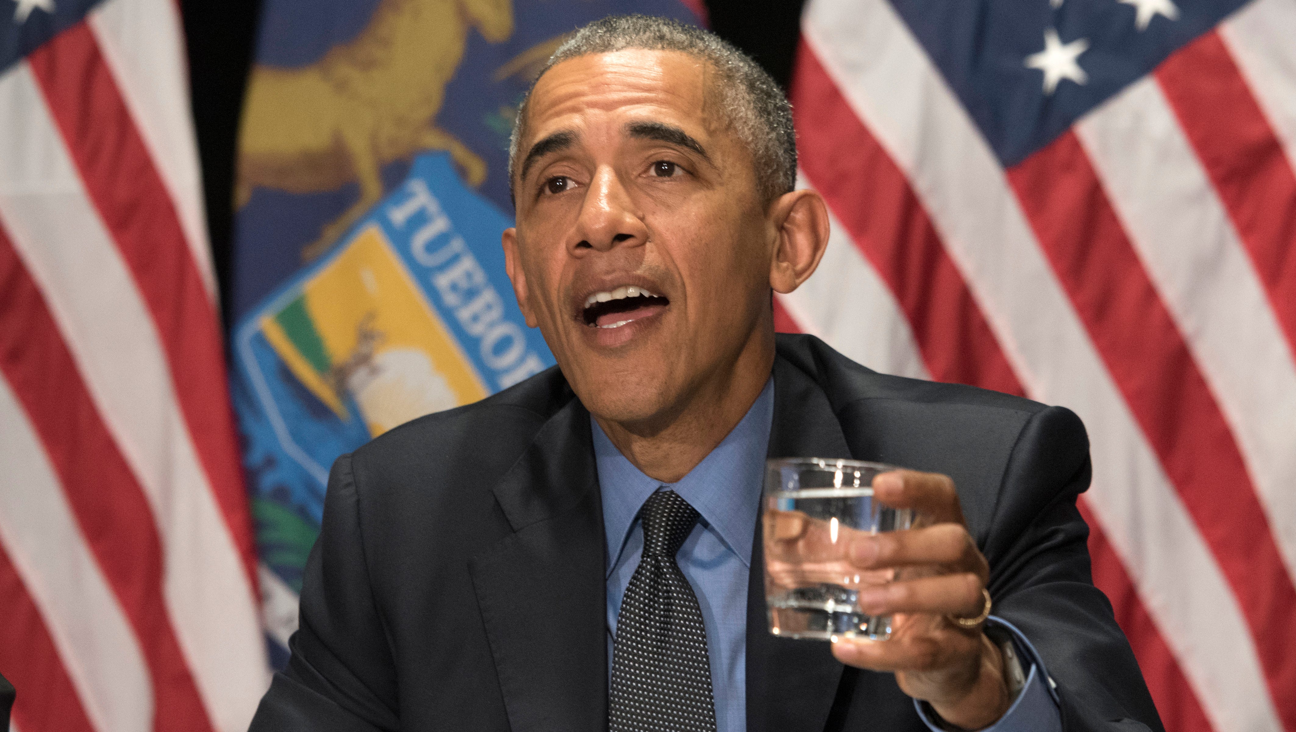 President Obama drinks a sip of filtered Flint water during a meeting with federal officials at the Food Bank of Eastern Michigan in Flint. "Generally, I haven't been doing stunts, but here you go," he said before drinking.