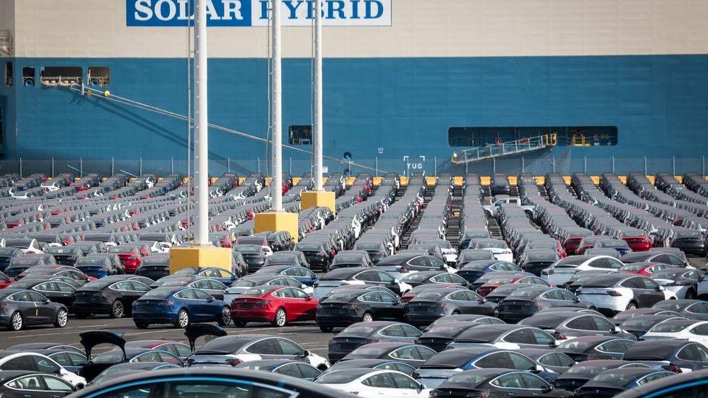 Tesla Inc. vehicles sit in a parking lot of a port before shipment.