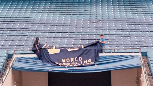 Crews take down WWF signage the day after WrestleMania III. Media reports from the time say the Silverdome was littered with trash.
