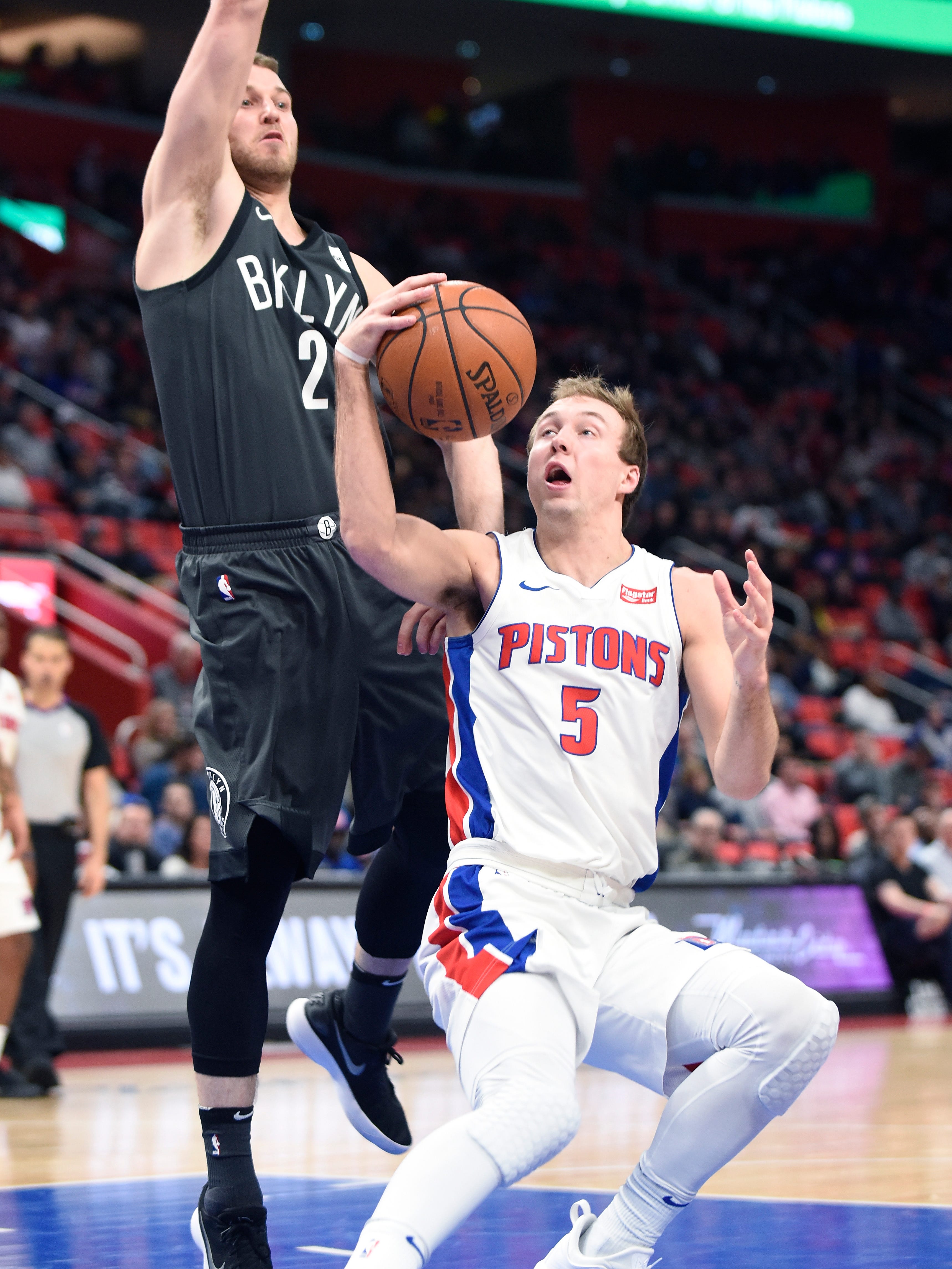 Pistons' Luke Kennard fakes out Nets' Nik Stauskas for a basket in the fourth quarter.