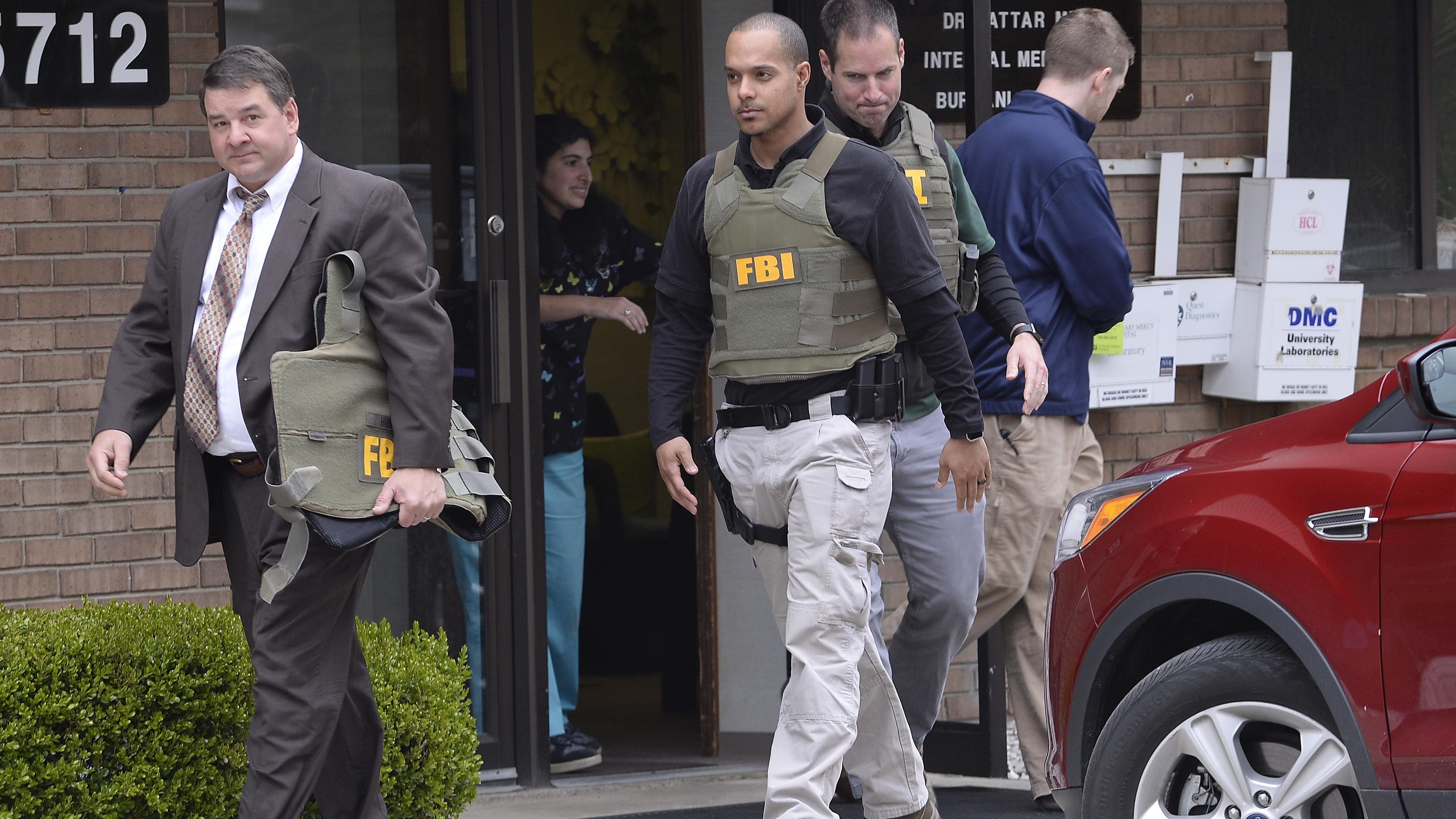 FBI agents leave the office of Dr. Fakhruddin Attar, Burhani Clinic in Aprial after completing a search for documents in the on going investigation of Jumana Nagarwala of Northville who is charged with female genital mutilation of two 7 year old girls. Livonia