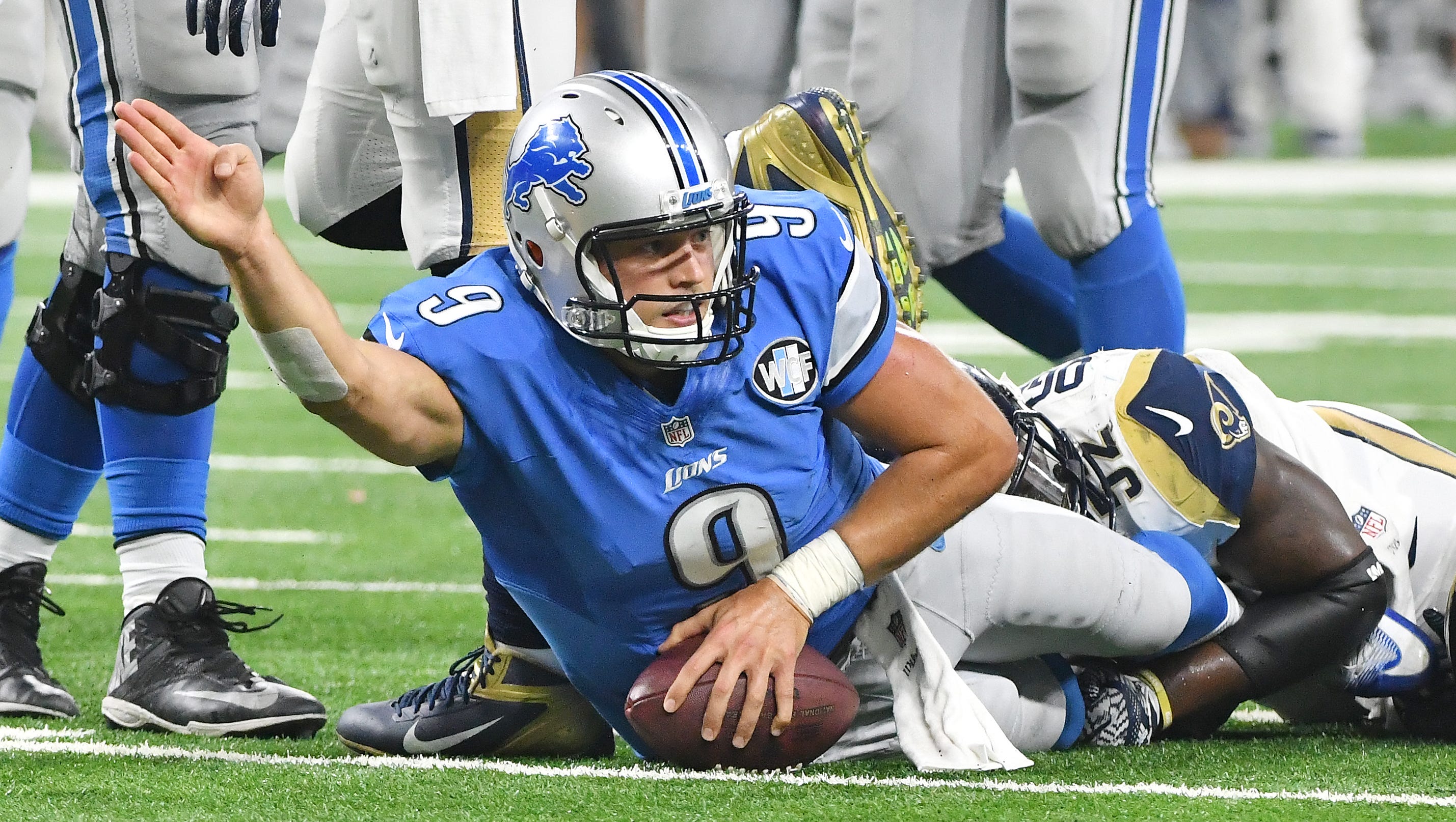 Lions quarterback Matthew Stafford signals for a first down after taking the ball and running it late in the fourth quarter.