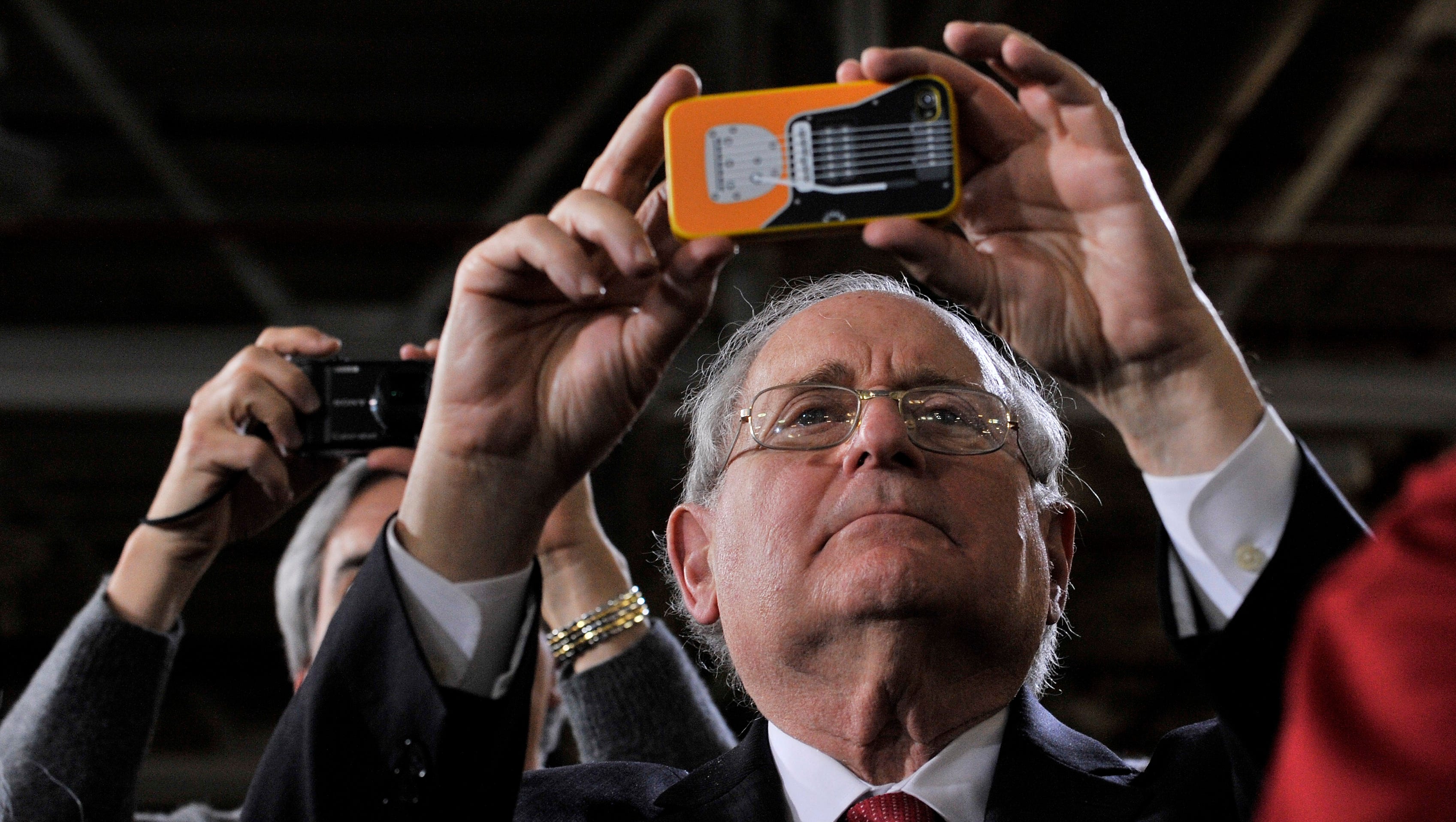 U.S. Sen. Carl Levin, D-Mich, takes a photo as President Barack Obama speaks at Detroit Diesel in Redford on Dec. 10, 2012. The Detroit Democrat, who chose not to seek re-election, said he plans to return to the state when he wraps up a political career that has focused on the military, manufacturing and other issues.