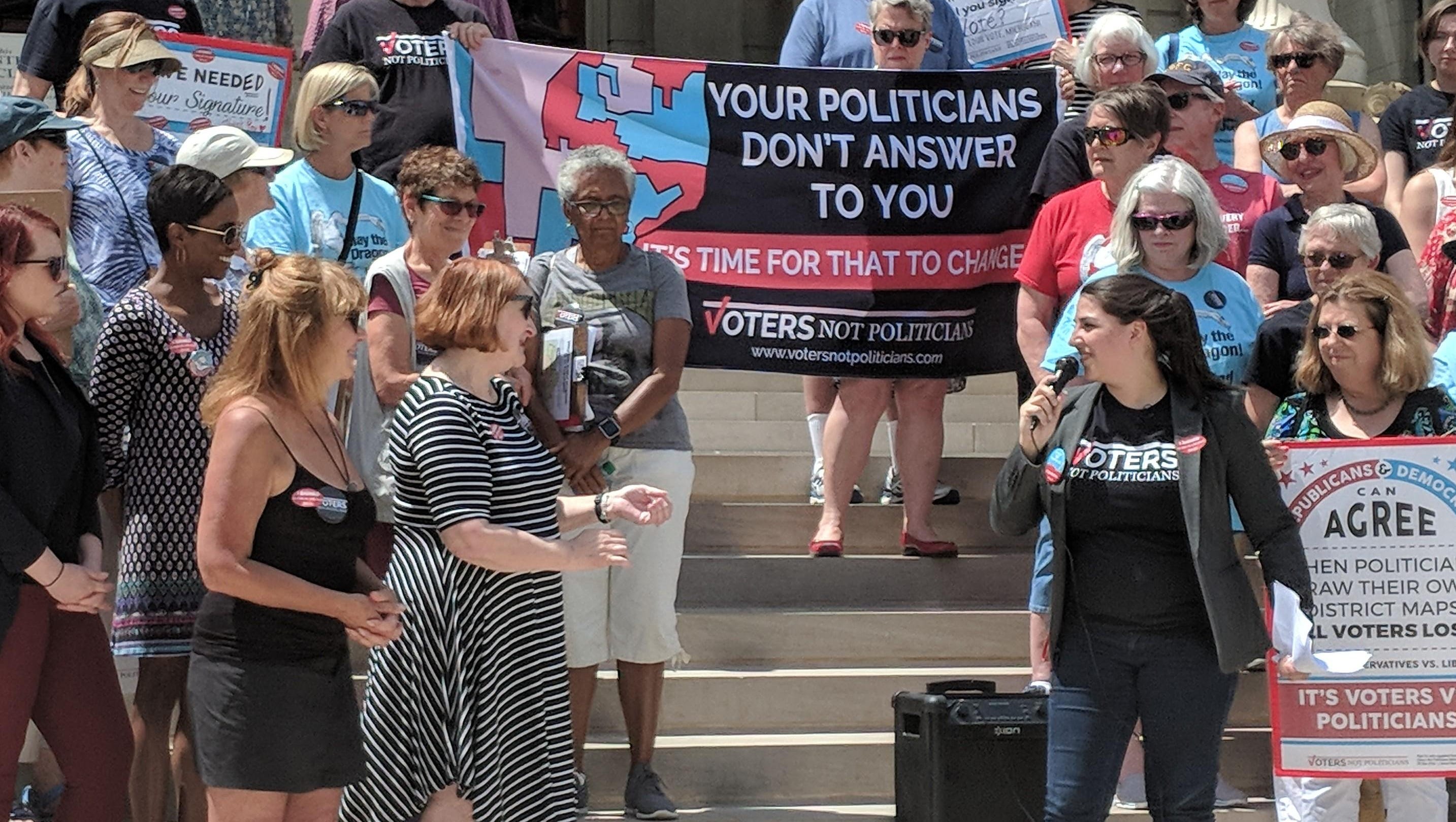Katie Fahey of Voters Not Politicians speaks to supporters at the Michigan Capitol on May 24, 2018.