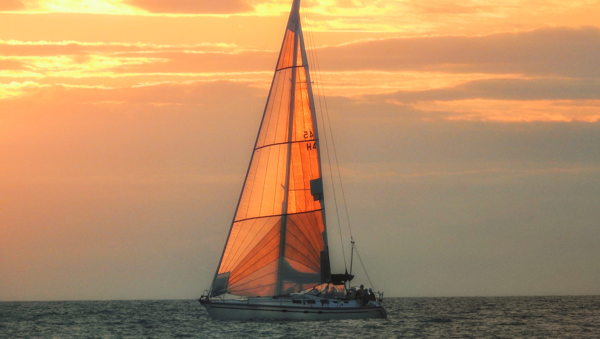"Fiery Sail on Lake Michigan," by Janette Dywasuk of Holland, was taken at sunset from Holland State Park.