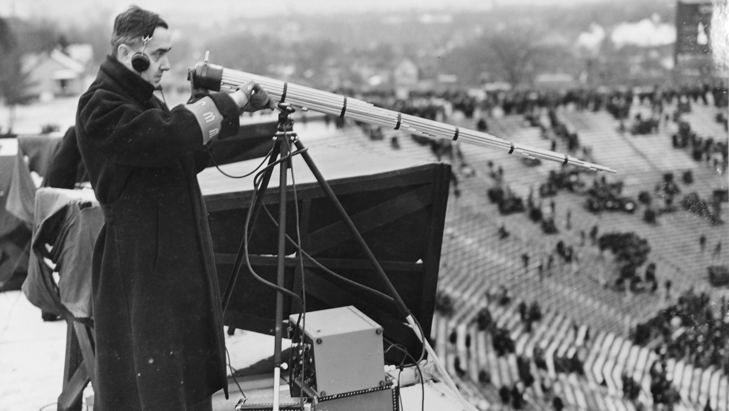 Walter Hoffman operates a machine gun (tubular directional) microphone at a University of Michigan football game on Nov. 24, 1937.