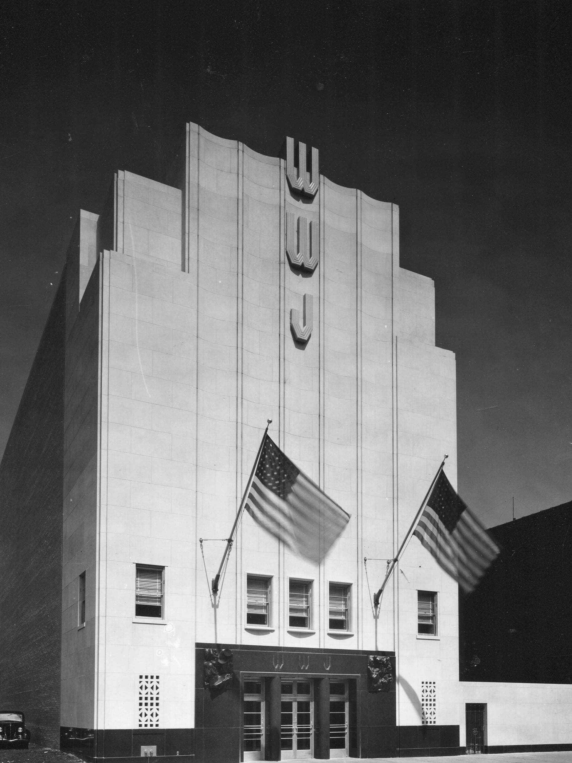 In 1936, a new Albert Kahn-designed building opened to house the WWJ-The Detroit News studios, across Lafayette from the Detroit News building.  Its 70-foot-high façade was made of Indiana limestone.  In the basement was the Detroit News Home Institute, a women’s activity center featuring five rooms of a modern dwelling to illustrate the principal divisions of the women’s department of The News, and a professional test kitchen.