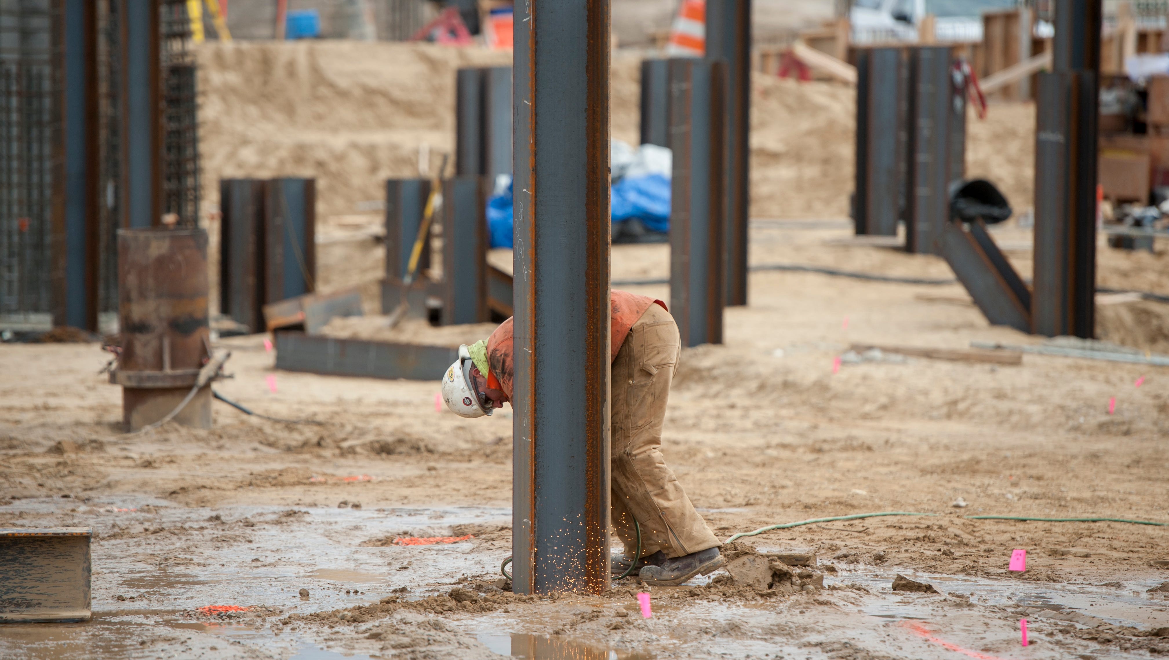 A laborer works on steel beams that are pounded into the ground at the construction site of the new Karegnondi Water Authority  treatment plant.
